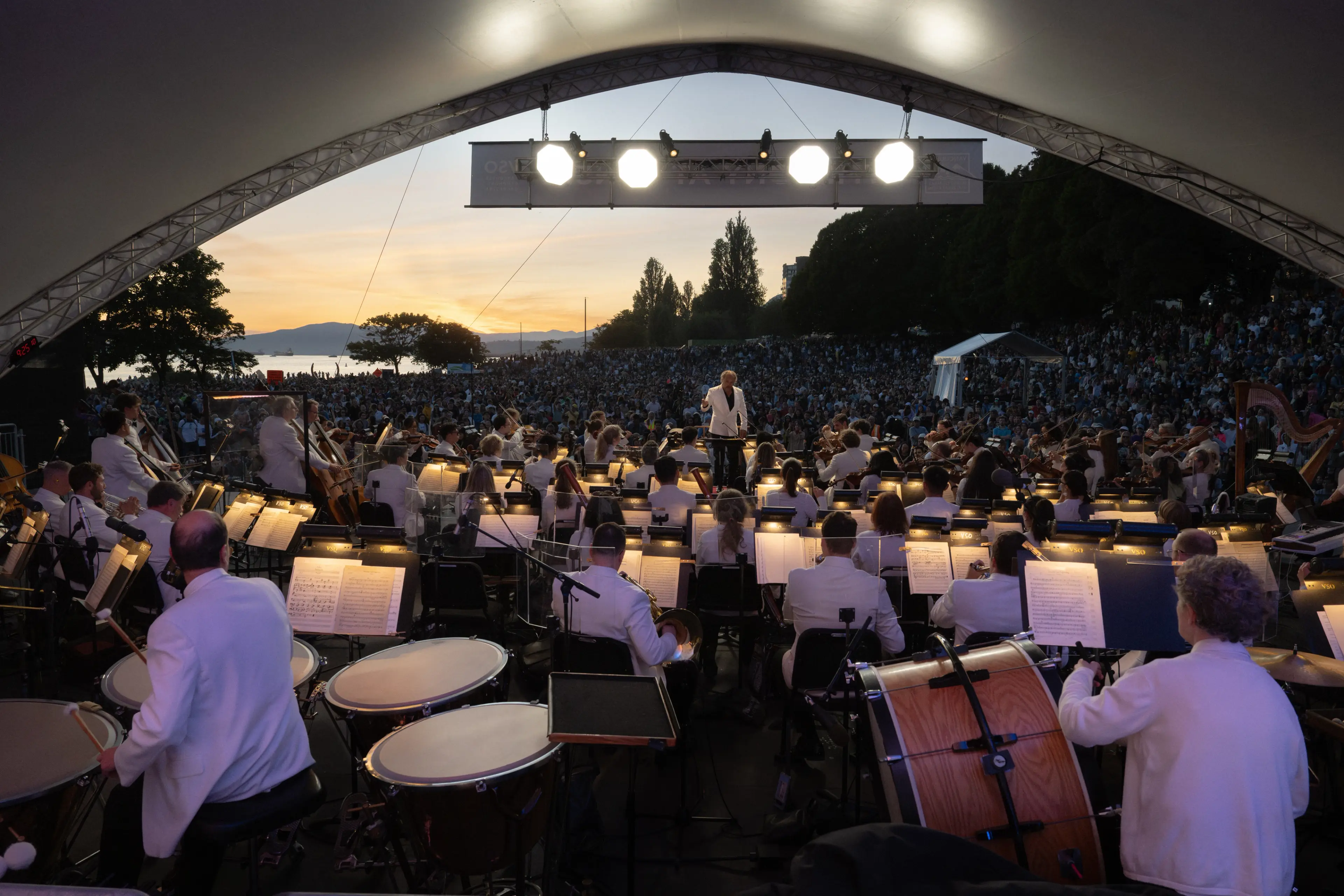 VSO at the open air Symphony at Sunset concert with Vancouver's ocean and mountains in the background.