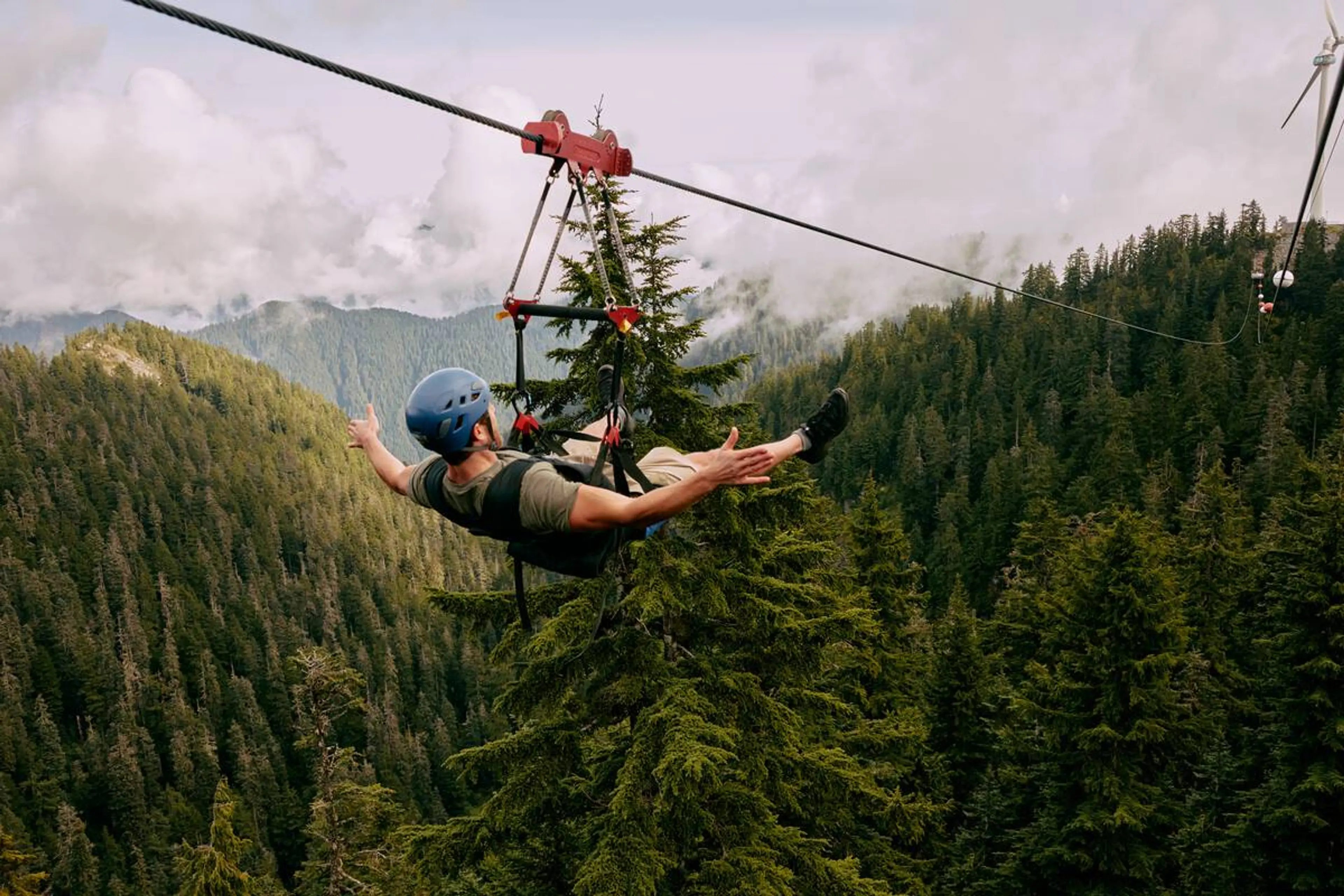 A person ziplines on Grouse Mountain. 