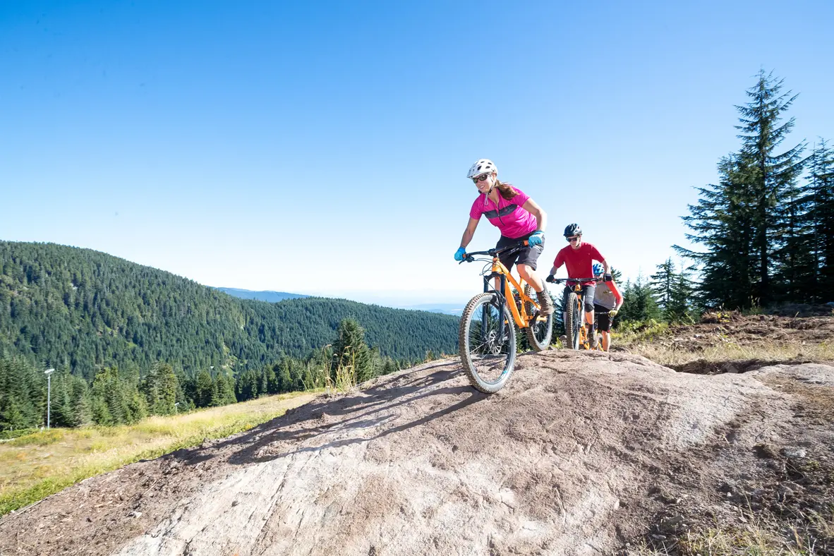 Mountain bikers on a rock slab at Grouse Mountain in North Vancouver, BC