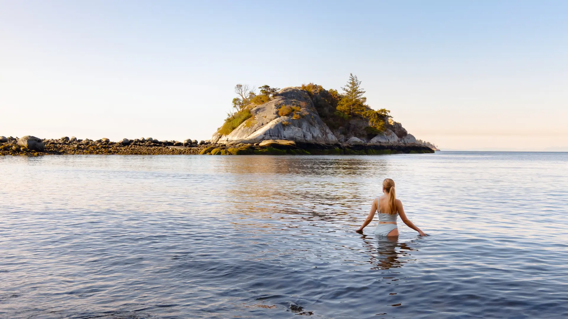 A woman swims in the ocean at Whytecliff Park in West Vancouver.