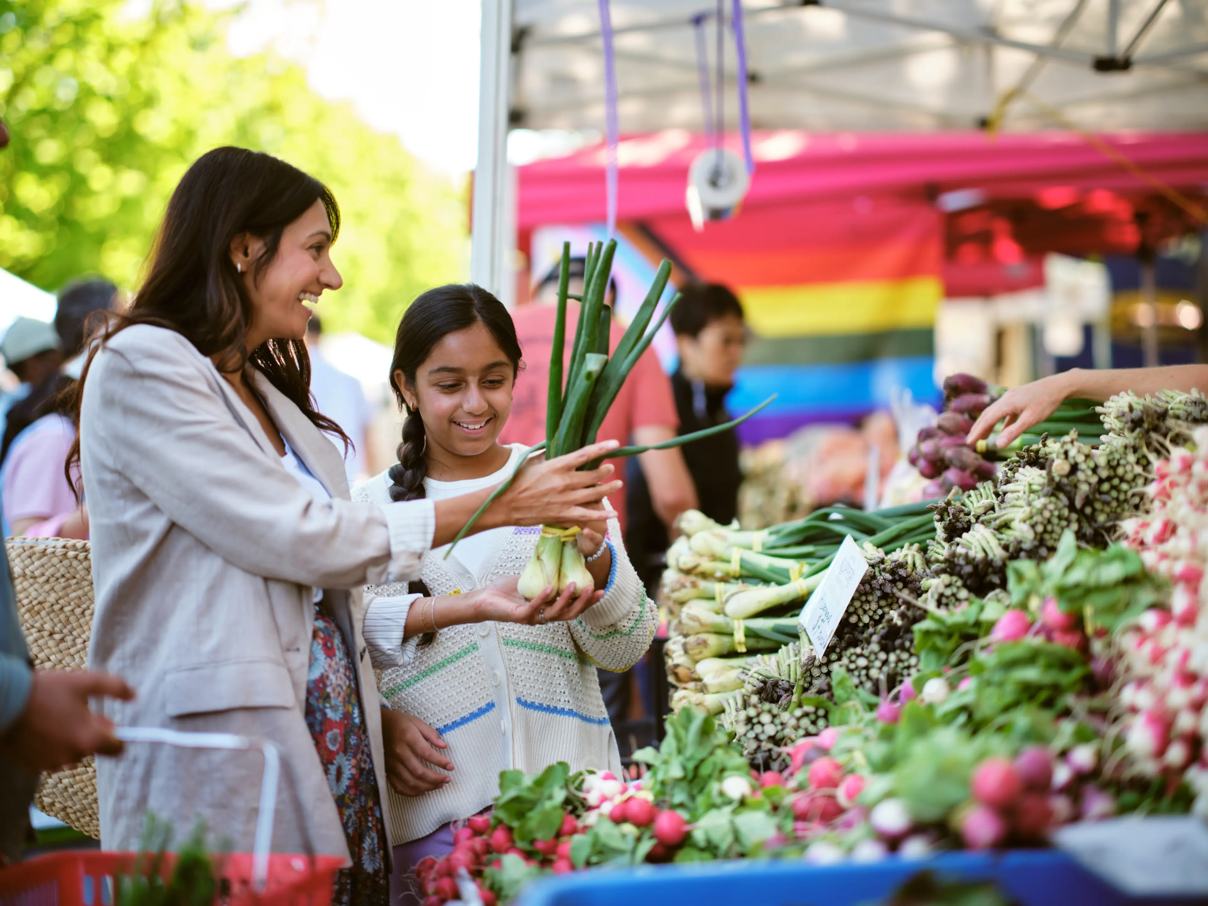 A mom and daughter going shopping at the Trout Lake Farmer's Market in Vancouver.
