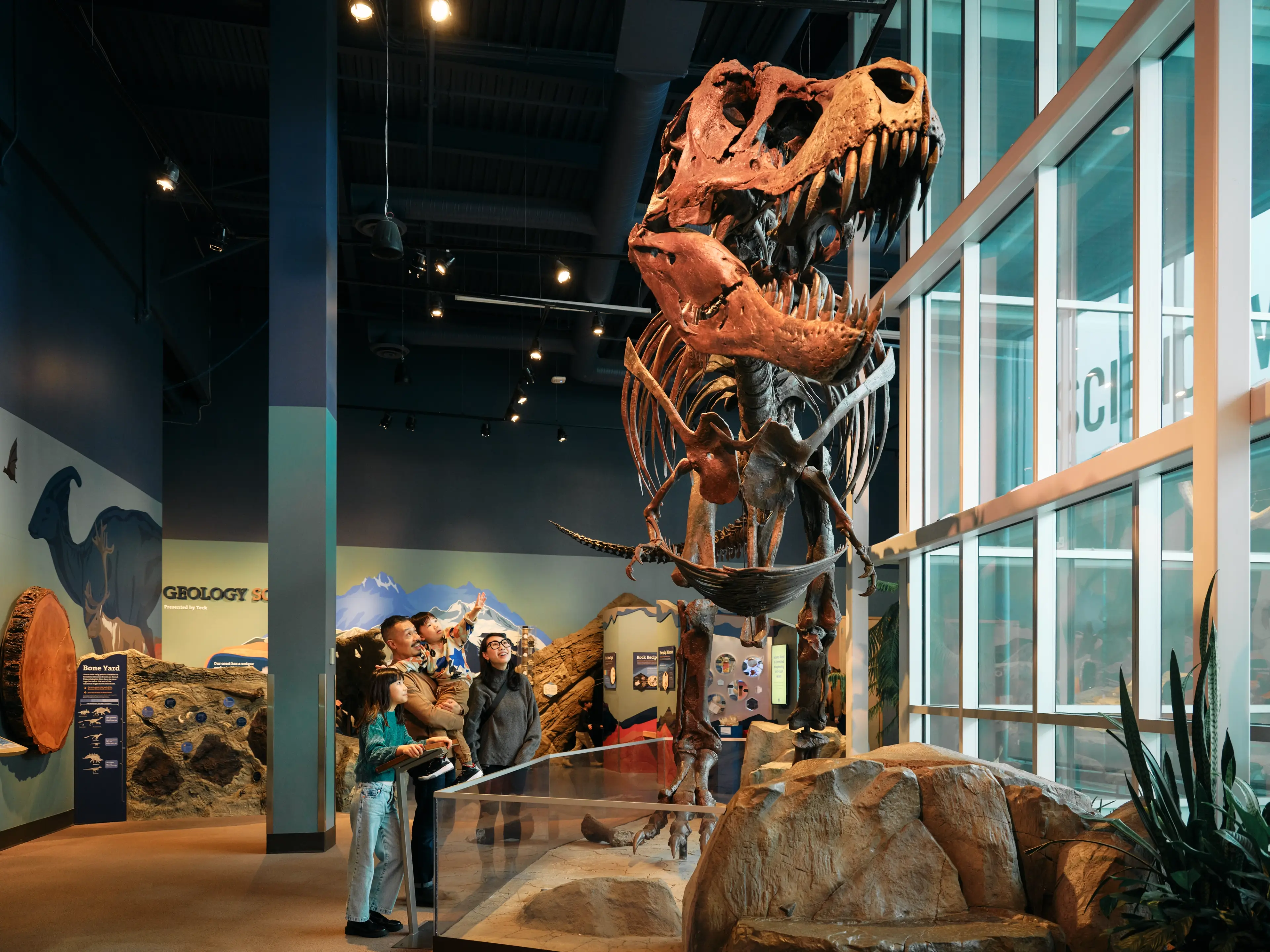 A family looks at a dinosaur skeleton at Science World