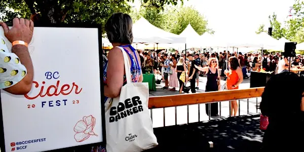 People mingle at booths at the BC Cider Fest