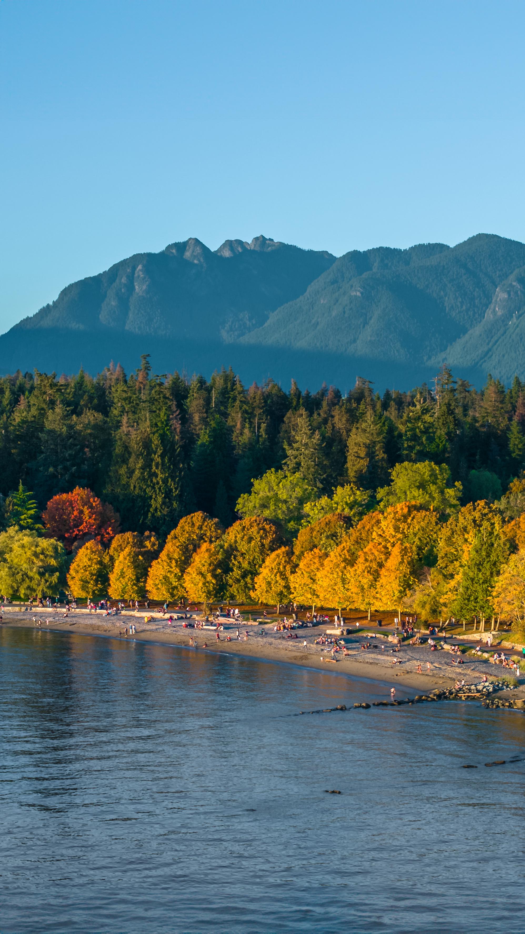 Vancouver fall coloured trees along coastline with mountains