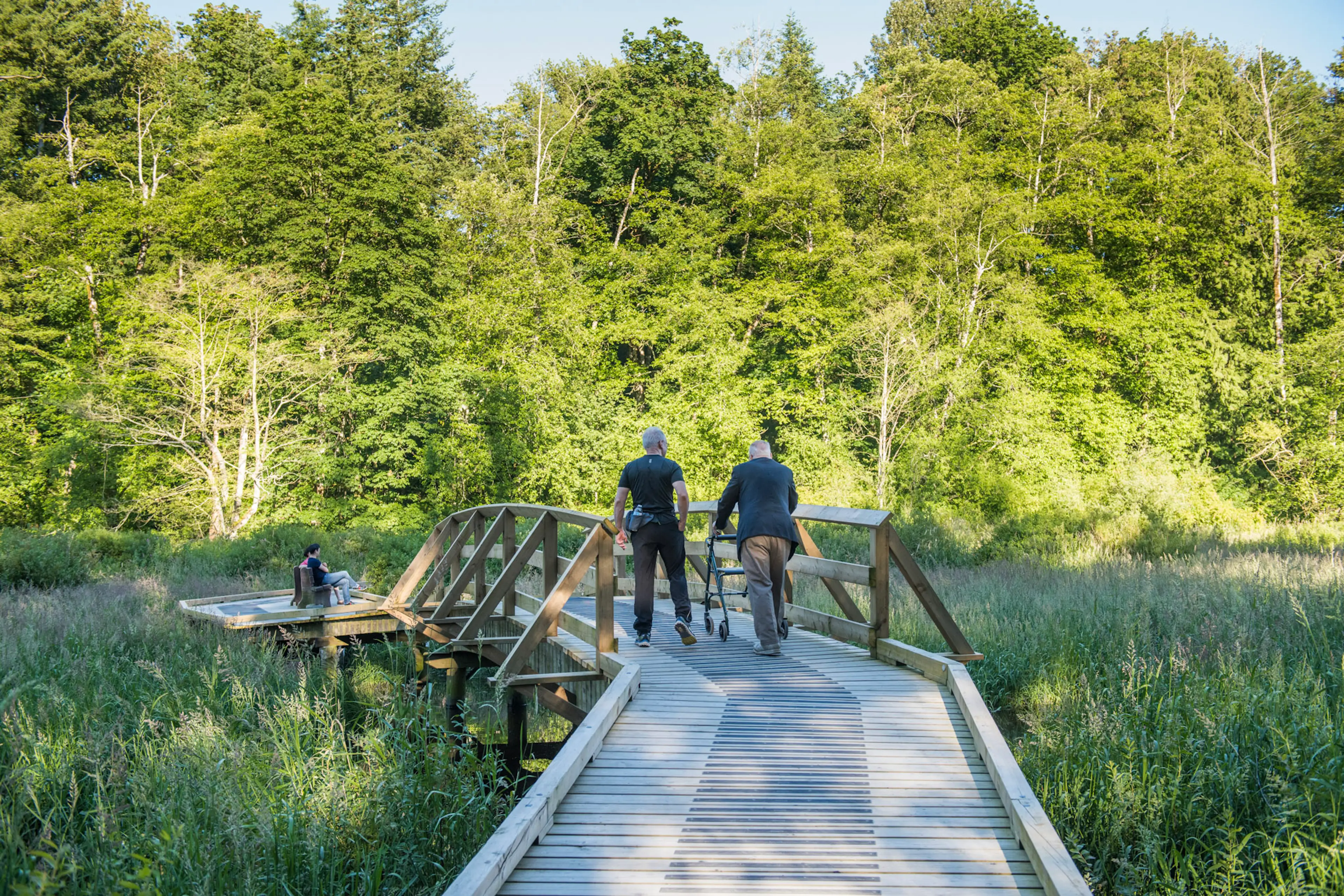 People walk on a boardwalk at Campbell Valley Regional Park in Langley