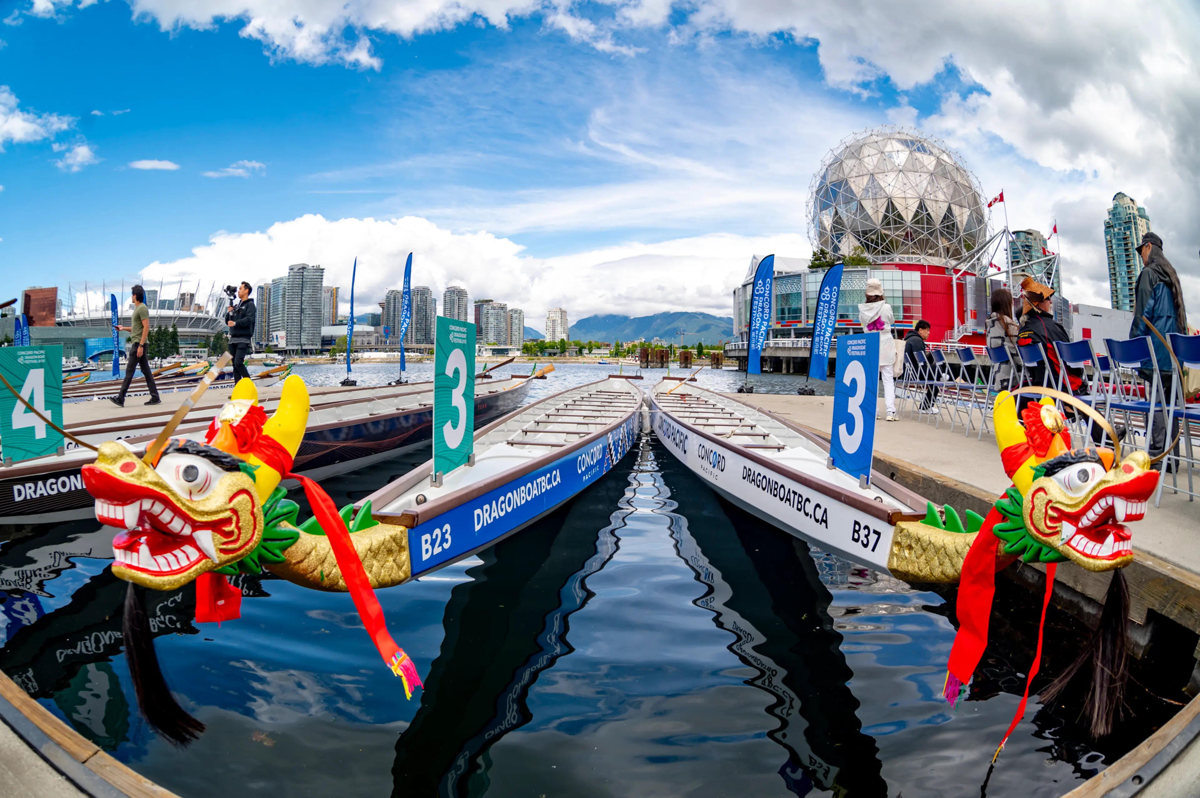 Two dragon boats with Science World in the background