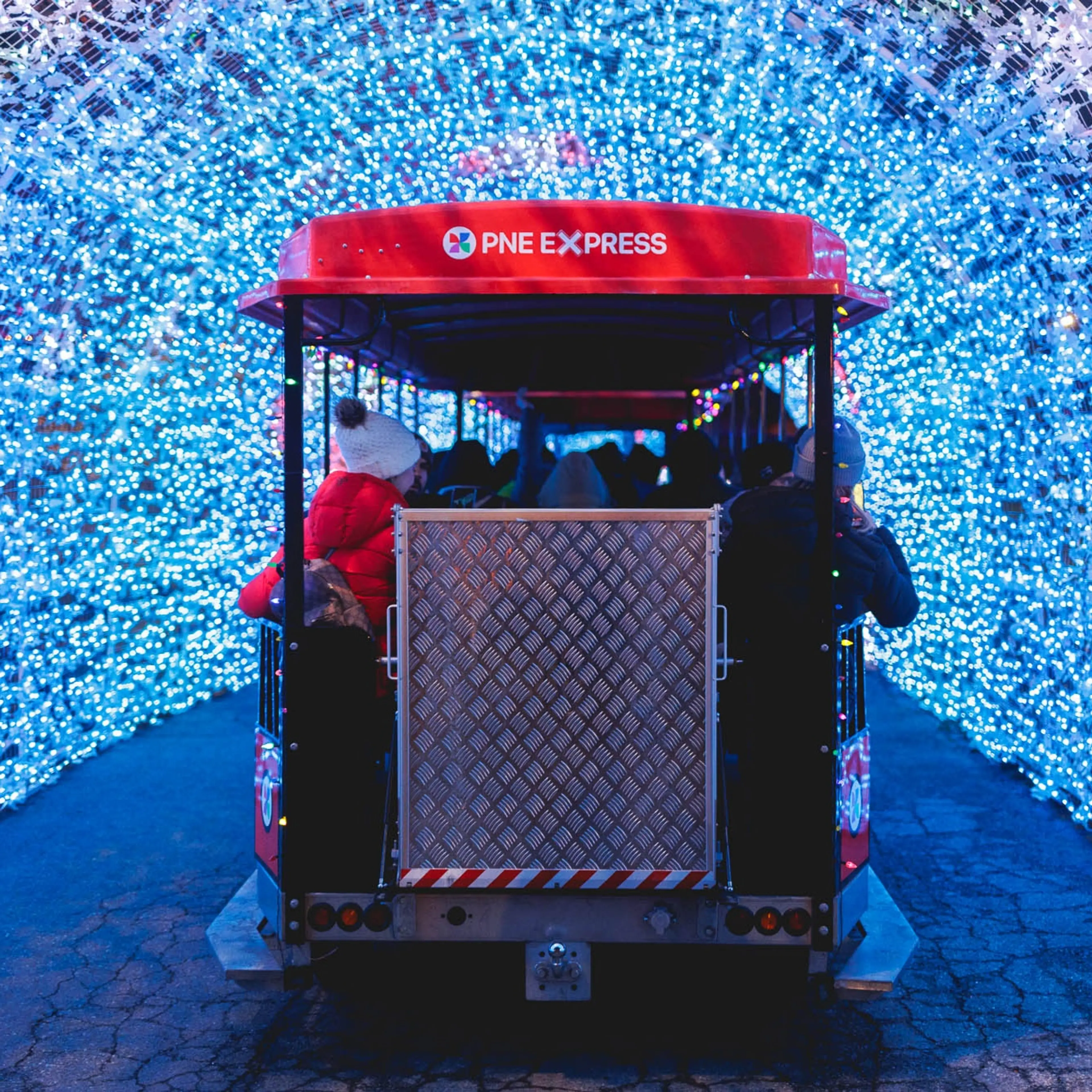 The back of the illuminated train at the PNE Winter Fair as it passes through a tunnel of lights. 