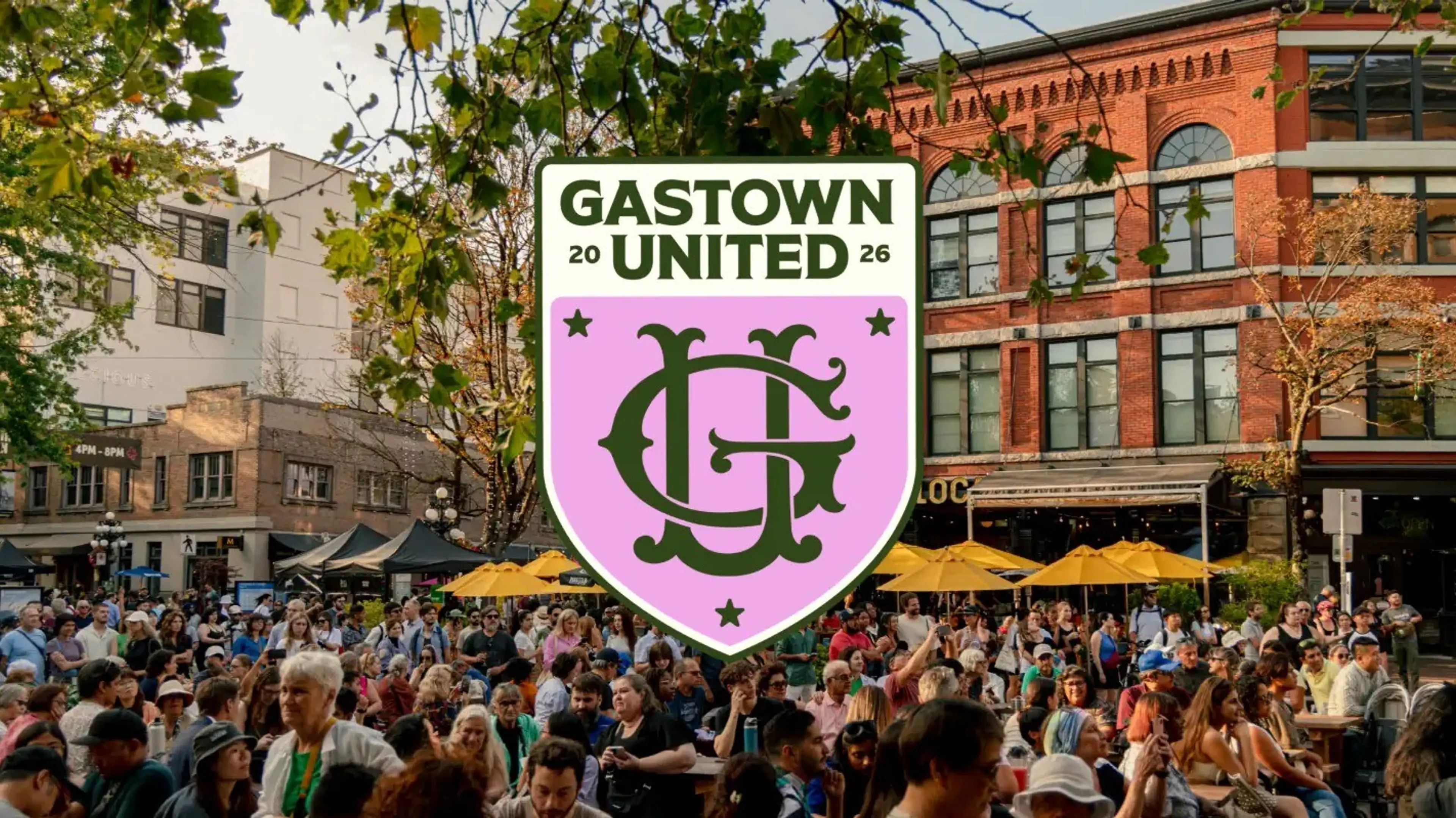 Crowd of people gathered outdoors in a city area with trees and buildings, overlaid with a Gastown United 2026 logo.