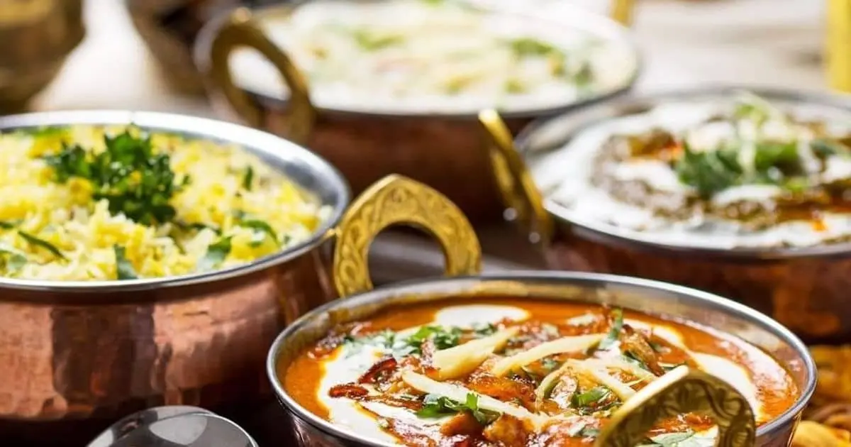 A variety of curries in decorative pots