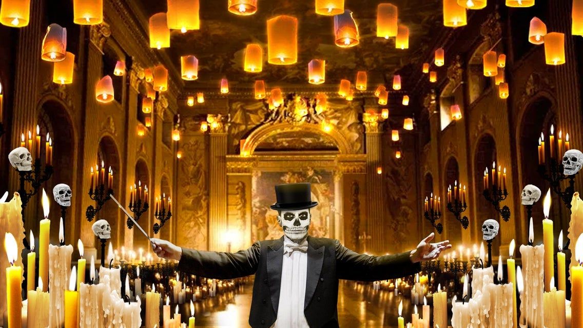 Person in skeleton face paint and top hat conducting in a grand hall with floating lanterns, candles, and skull decorations.