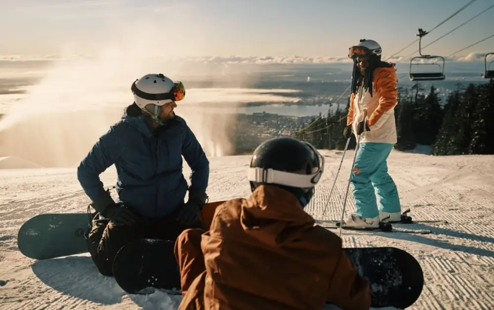 Friends skiing and snowboarding on a snowy mountain