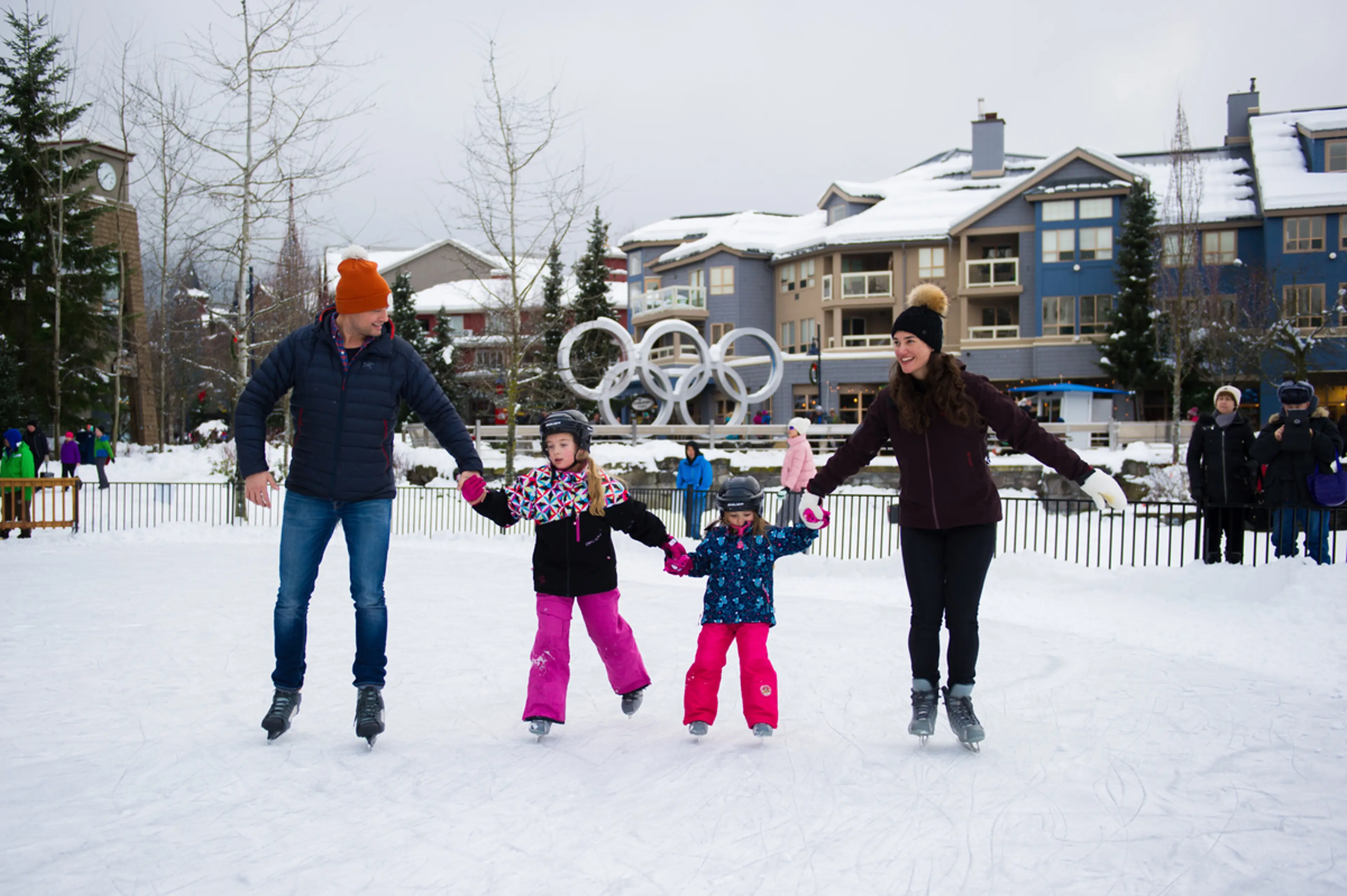 A family skating on an outdoor rink in Whistler