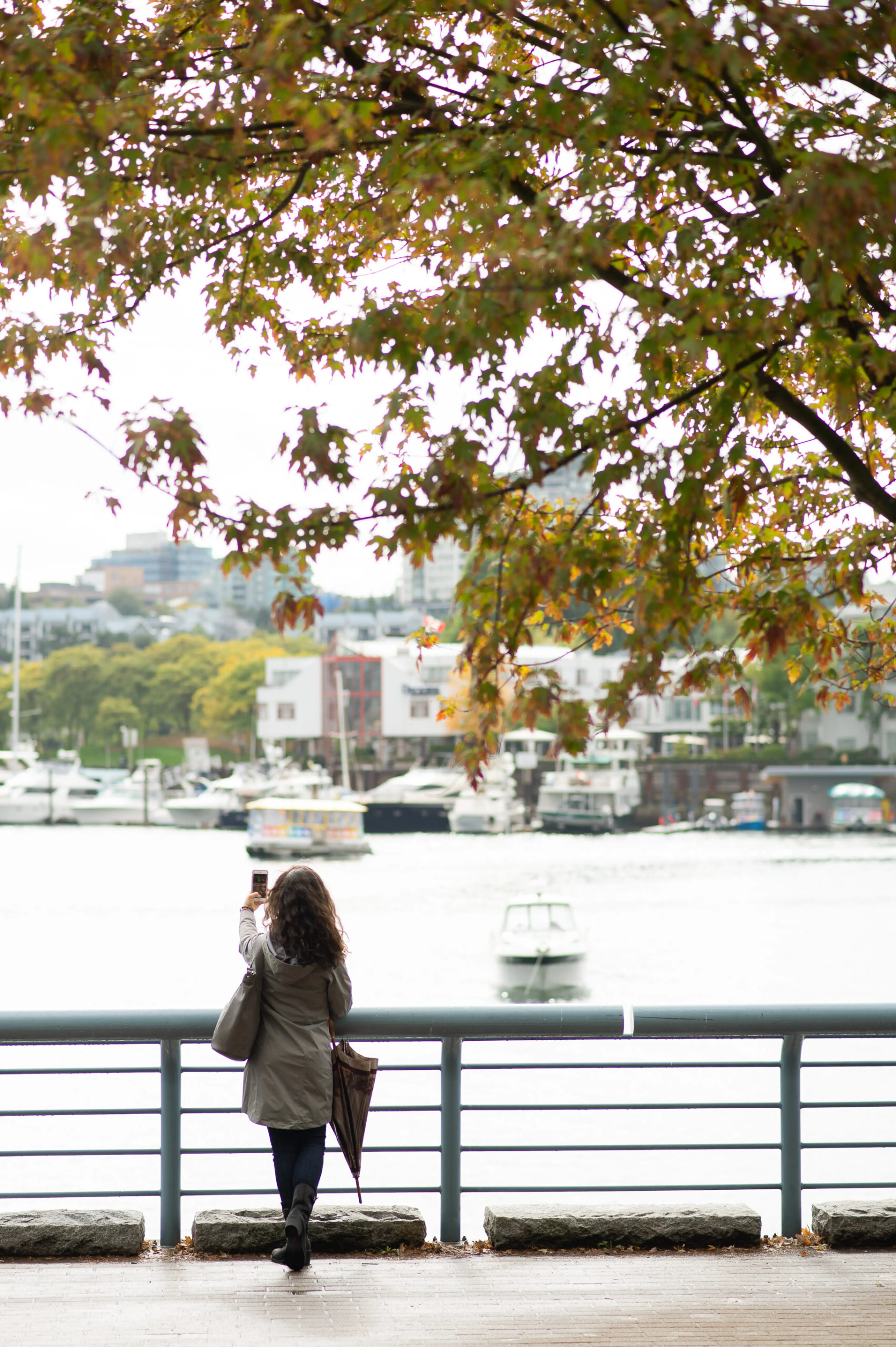 Woman taking photo during autumn in Vancouver