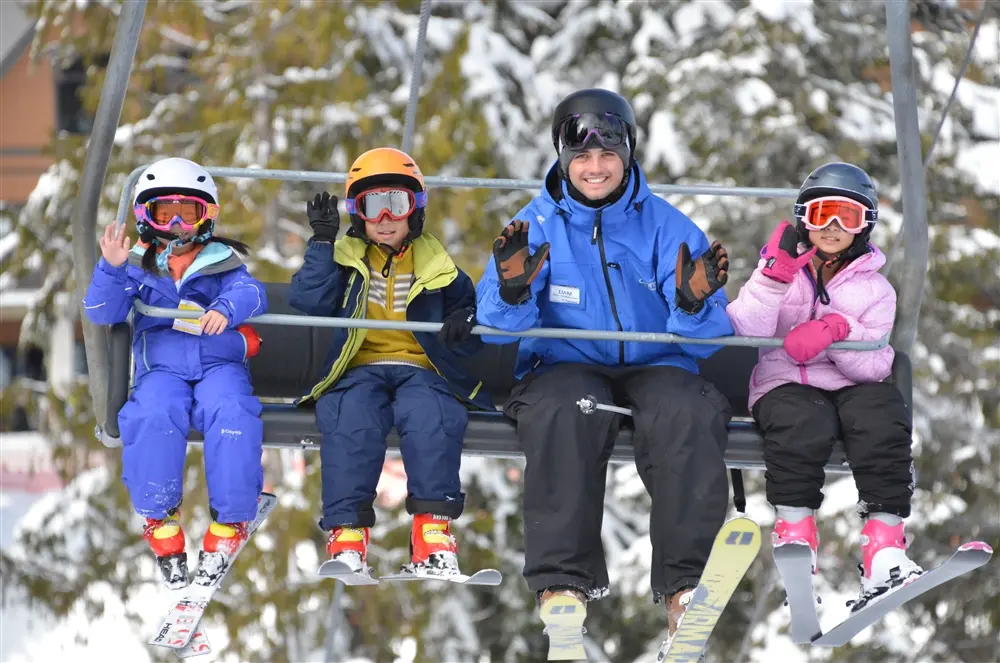 Kids ride the chairlift with their instructor during a ski lesson at Cypress Mountain in Vancouver