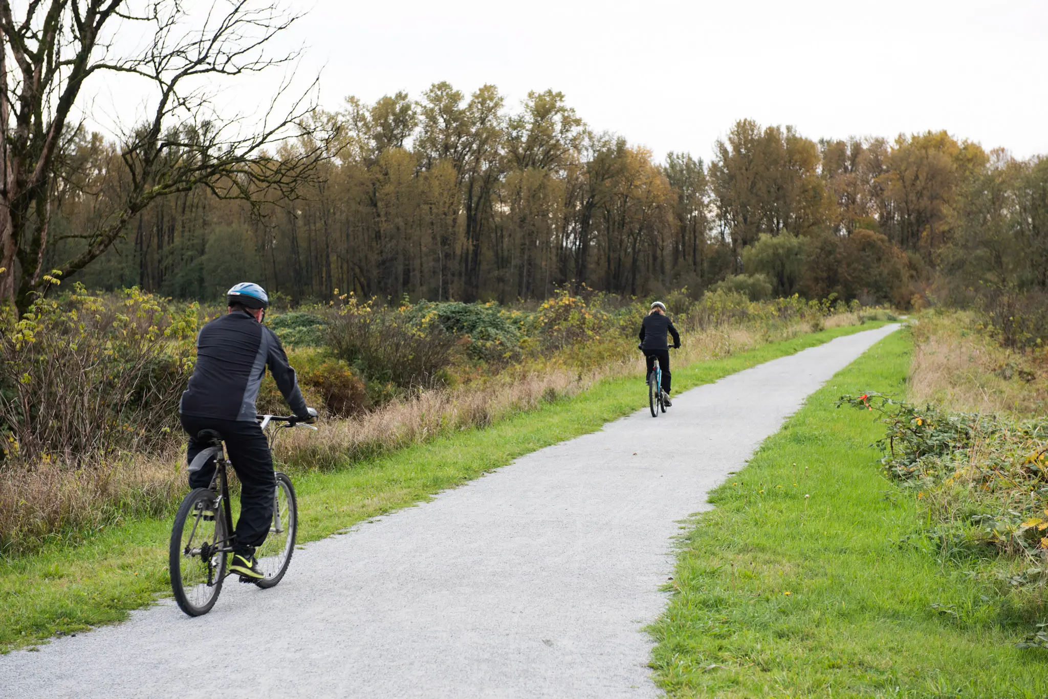 Cyclists in Colony Farm Regional Park