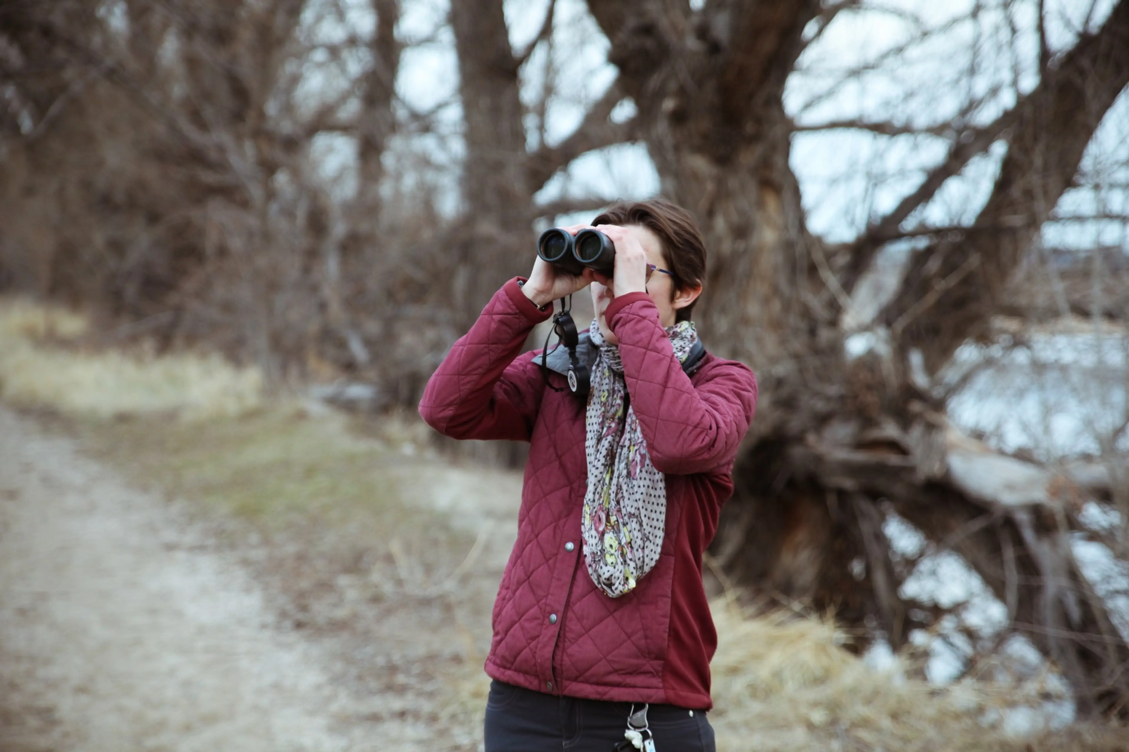 Woman with binoculars watching birds