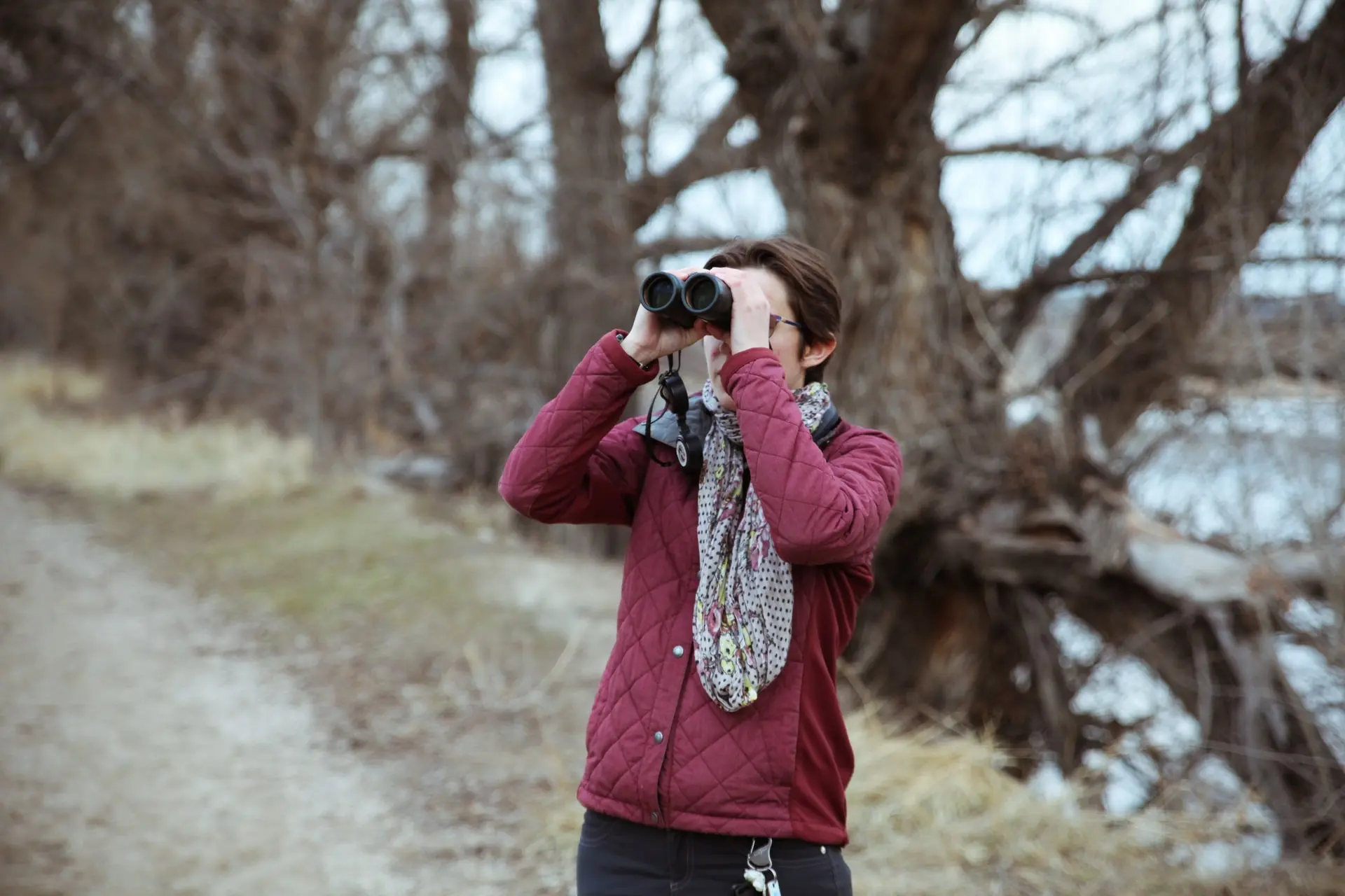 Woman with binoculars watching birds