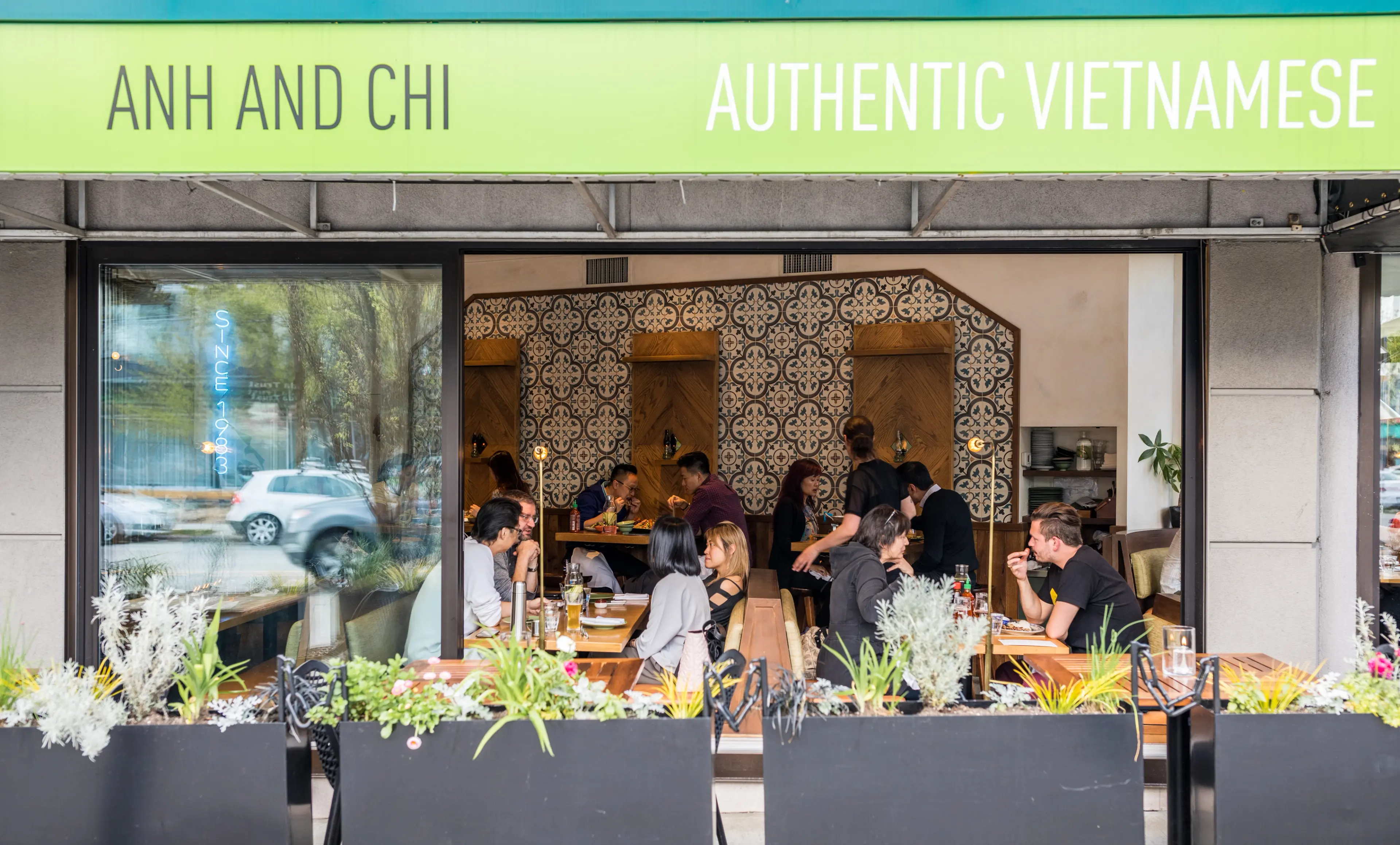 Exterior shot of people dining at Anh & Chi