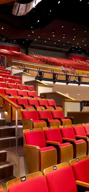 Red folding theater seats and a staircase