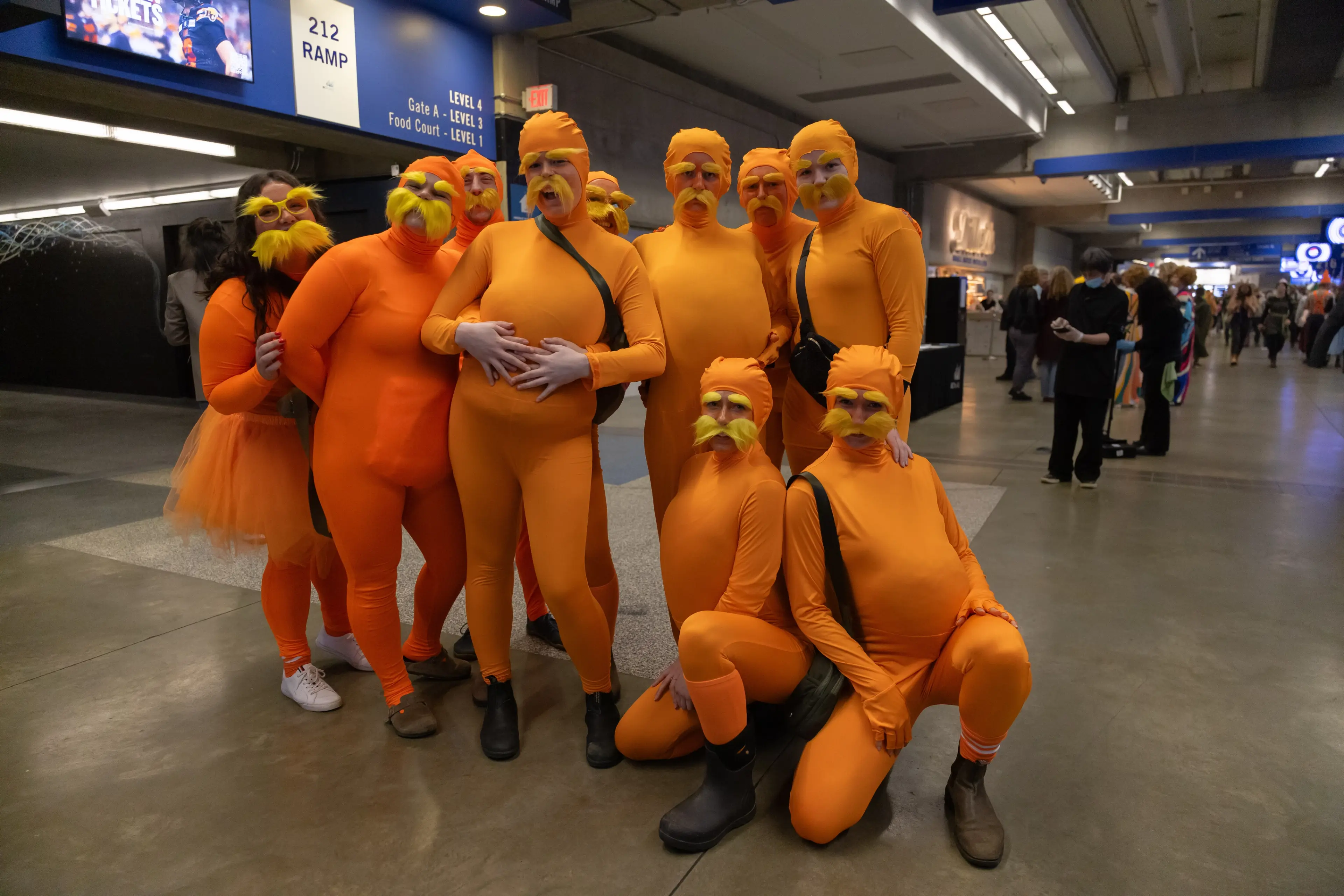 A group of friends in costumes at the Rugby Sevens event.