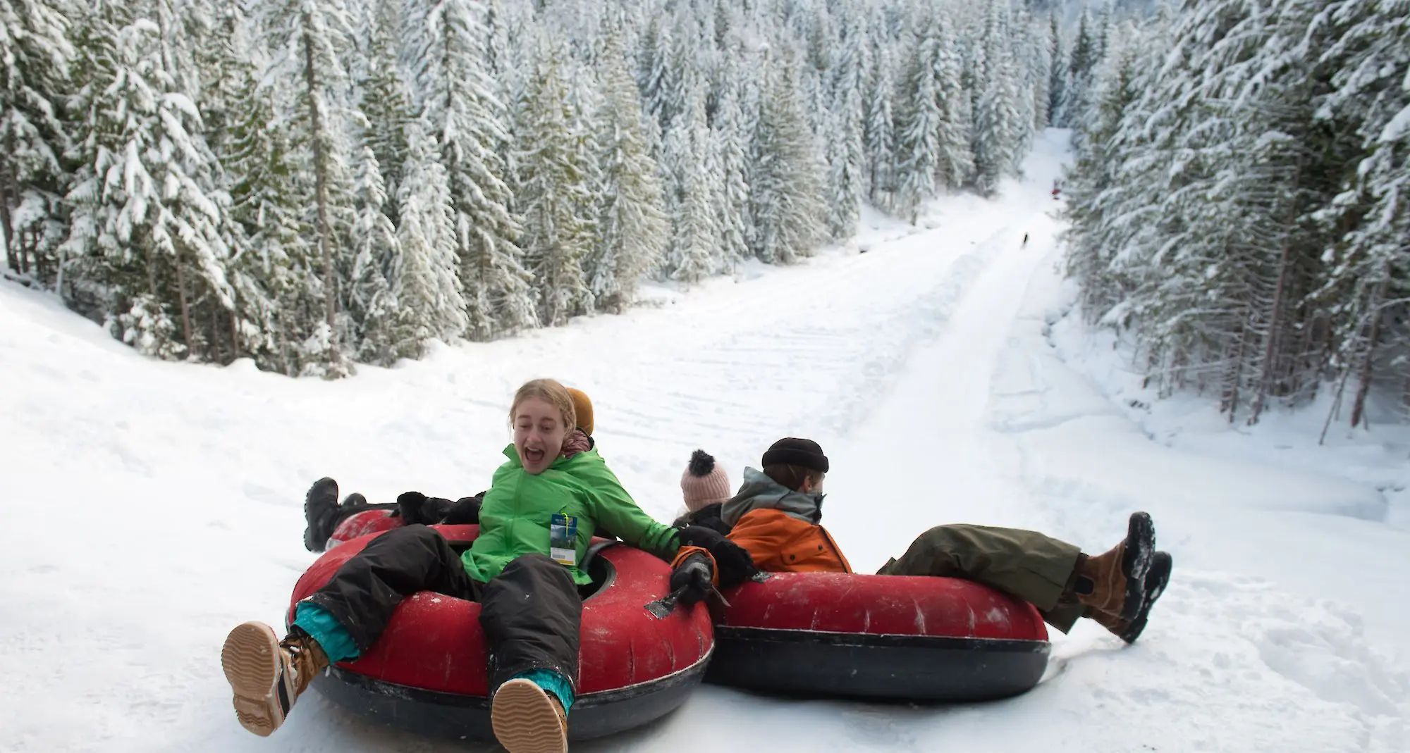 Kids on snow tubes at the Sea to Sky Gondola near Vancouver