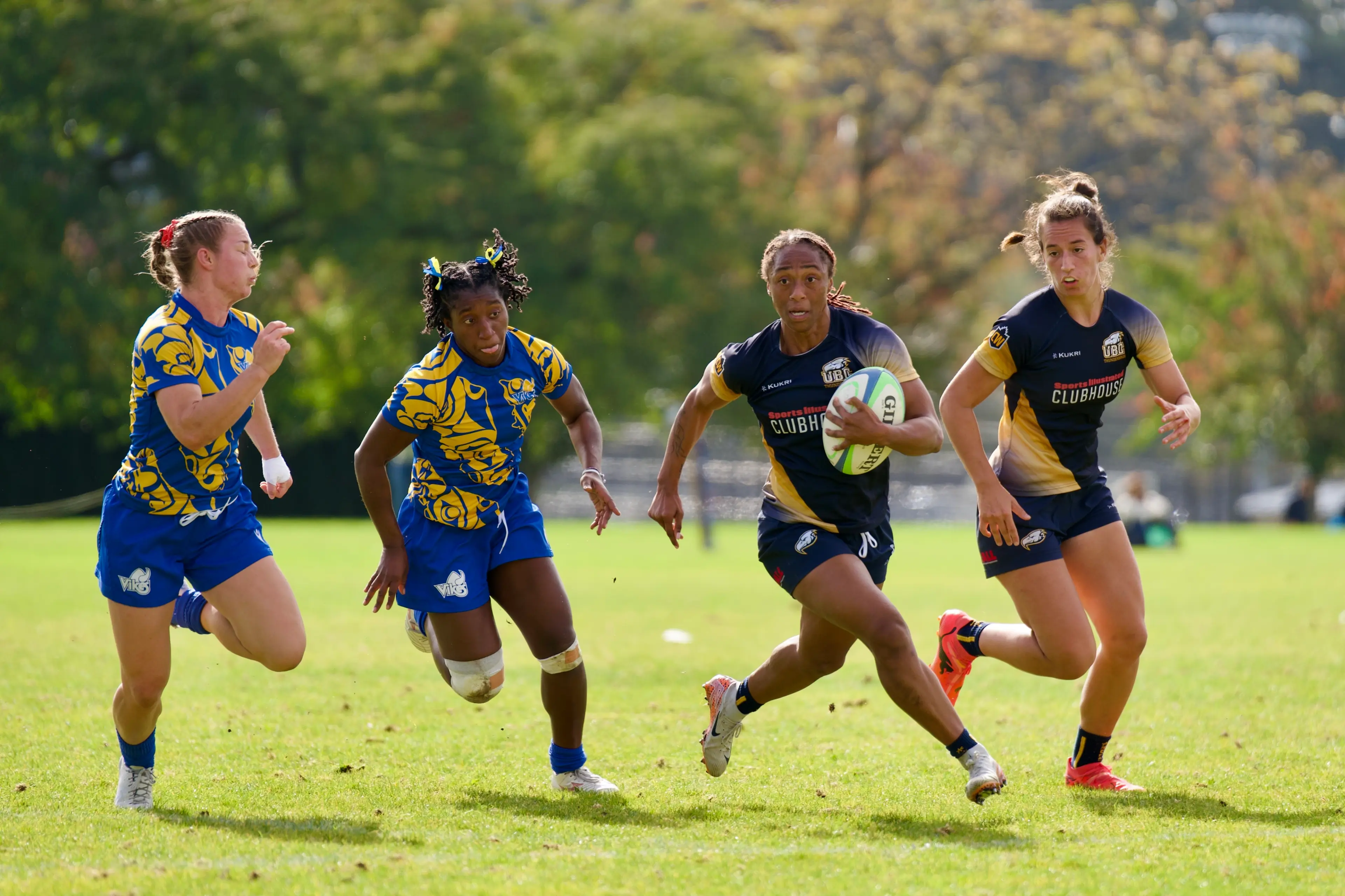 Action shot of two women rugby teams playing against each other.