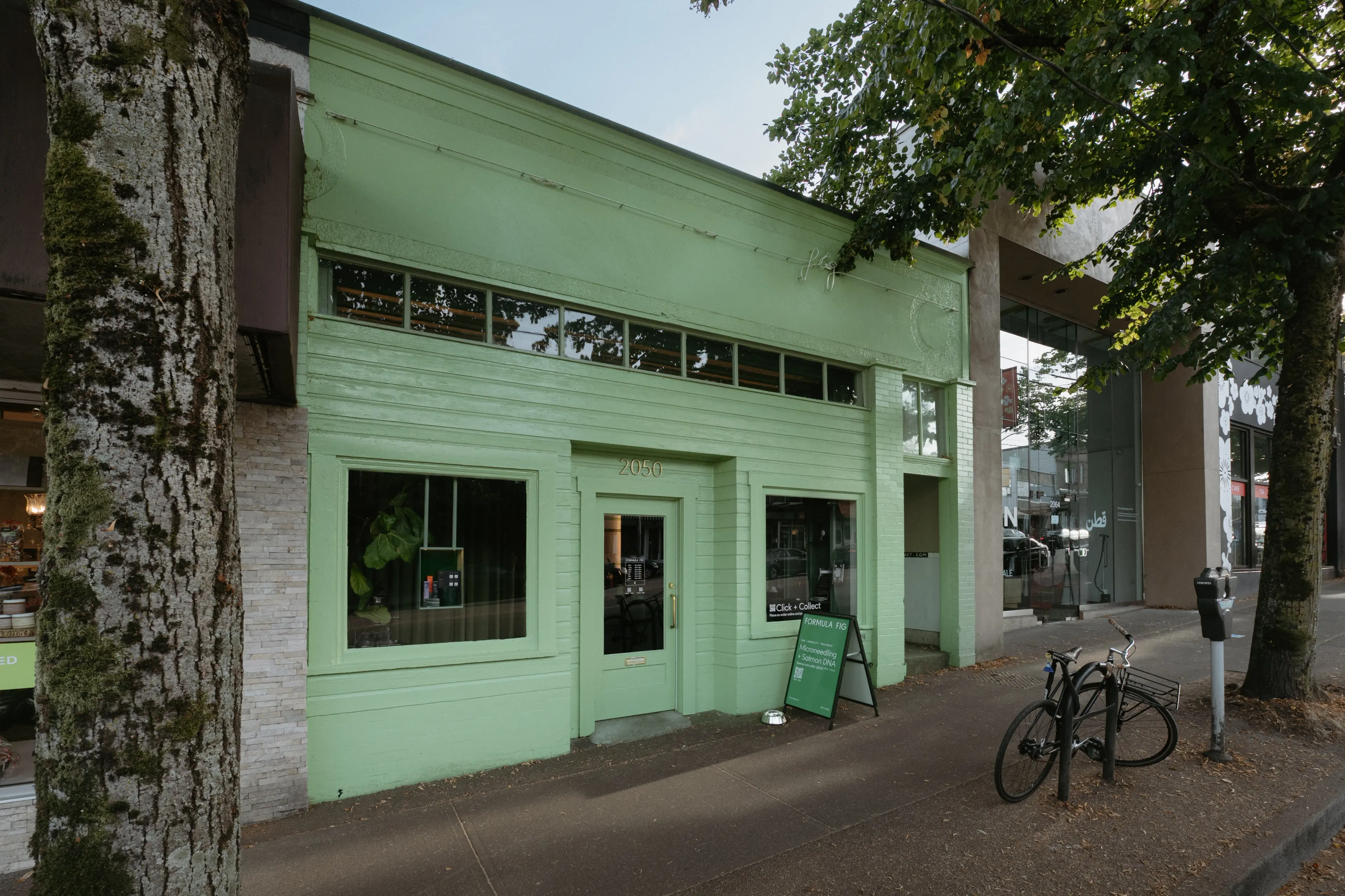 Exterior of a mint green heritage building which is the Formula Fig Beauty Bar in Vancouver.