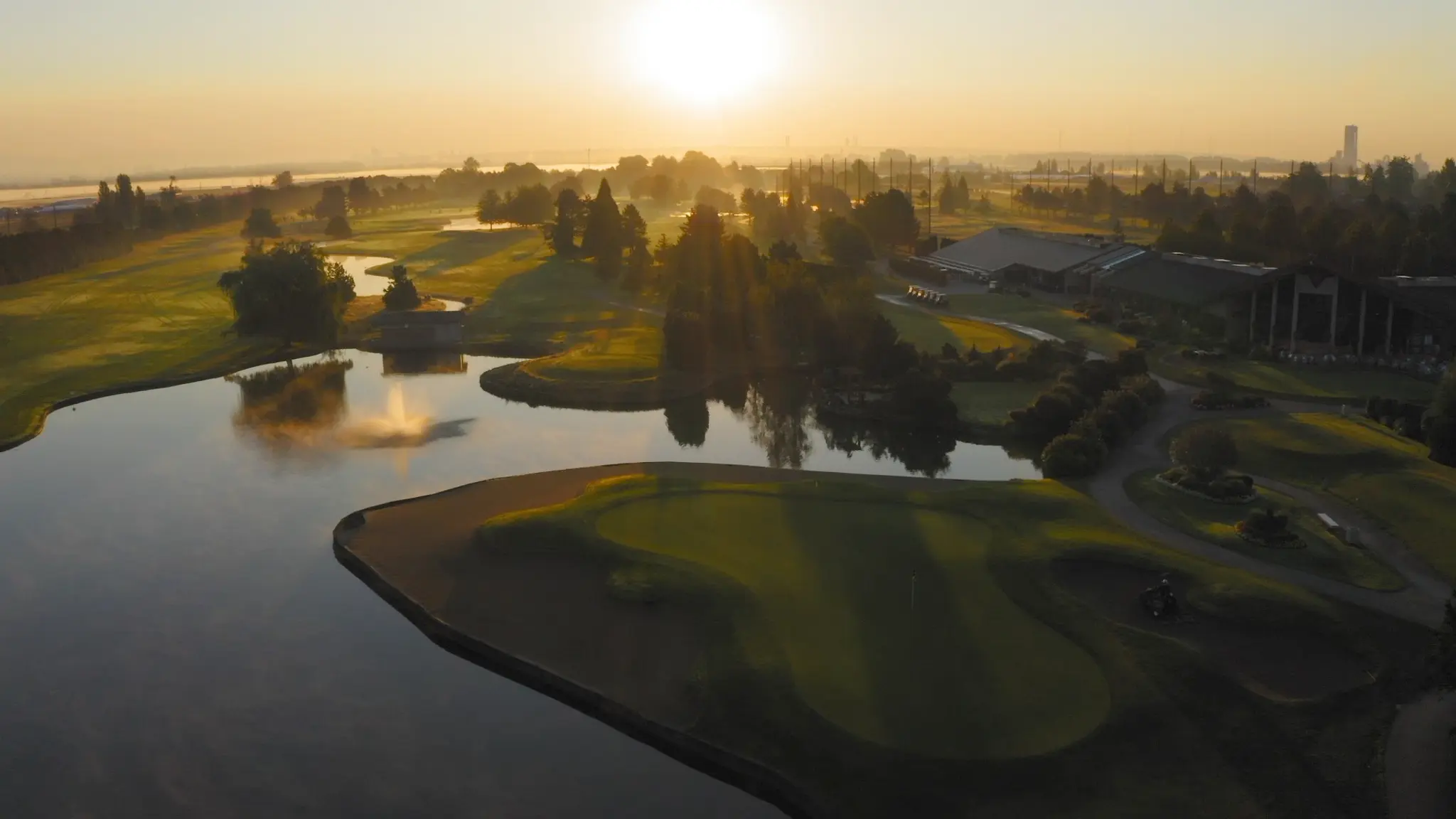 An aerial view of the Mayfair Lakes Golf & Country Club as the sun sets. 