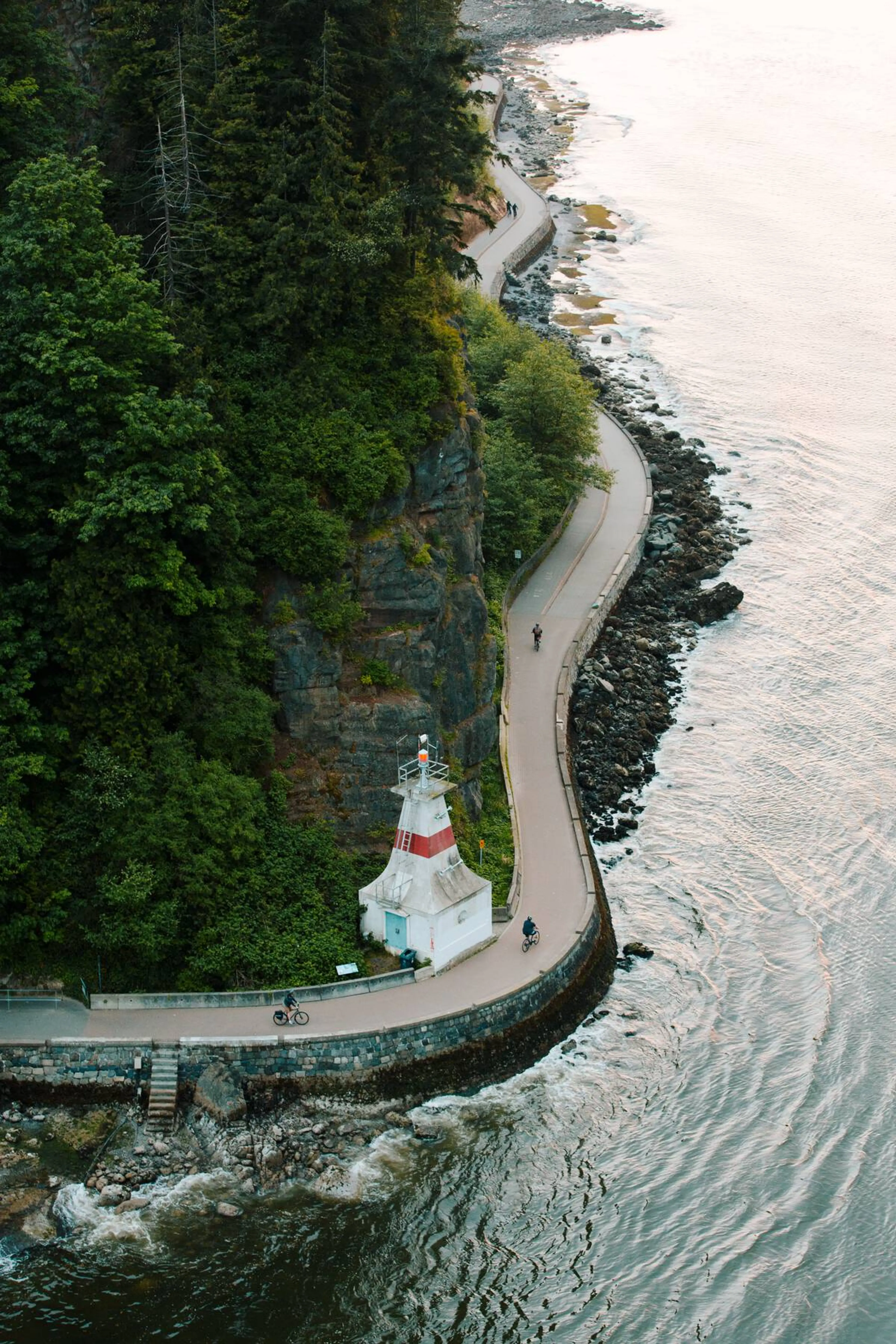 People walking and biking along the Stanley Park Seawall.