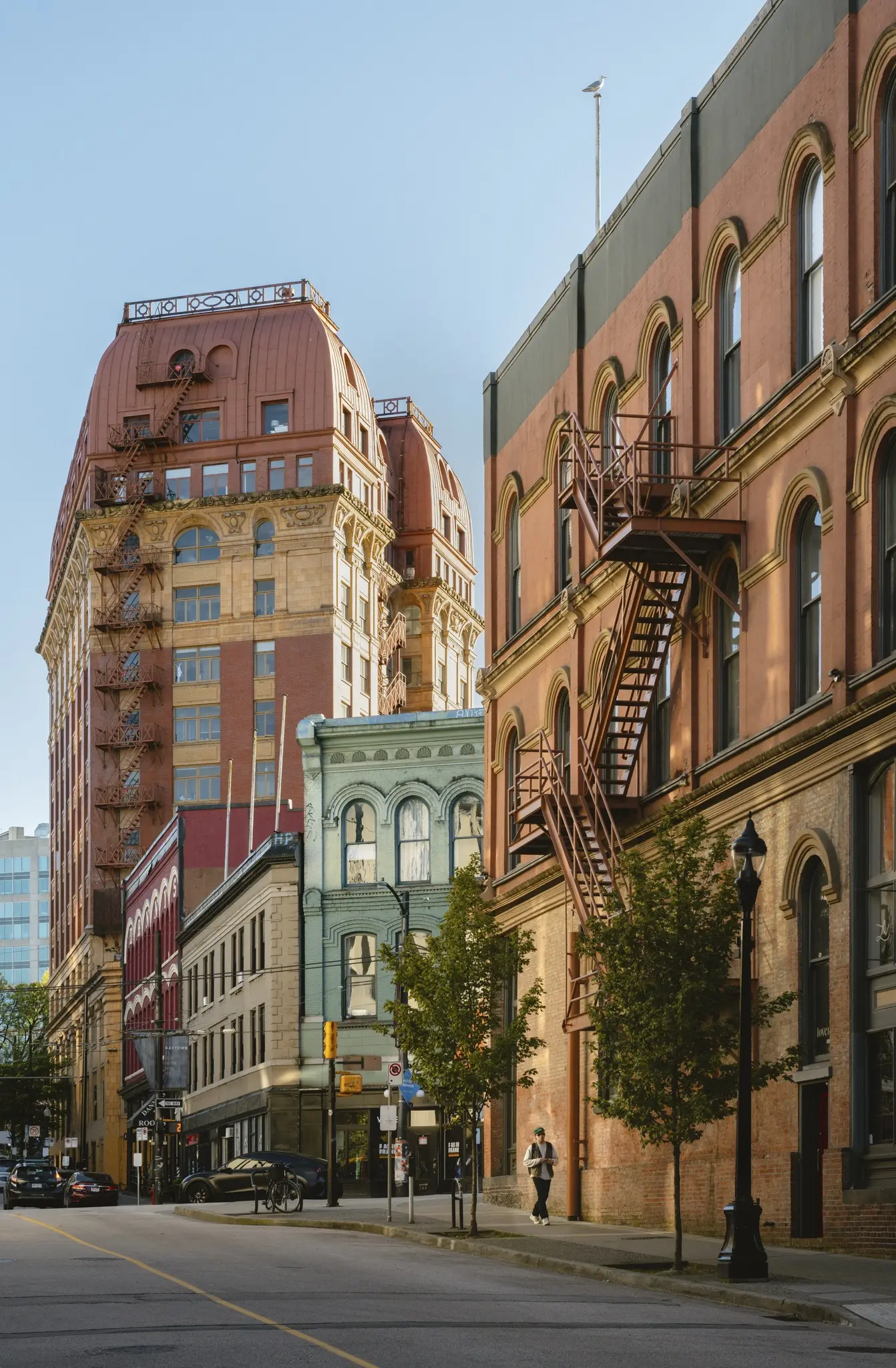 Colourful historic buildings with arched windows in pink, red, blue, and white.