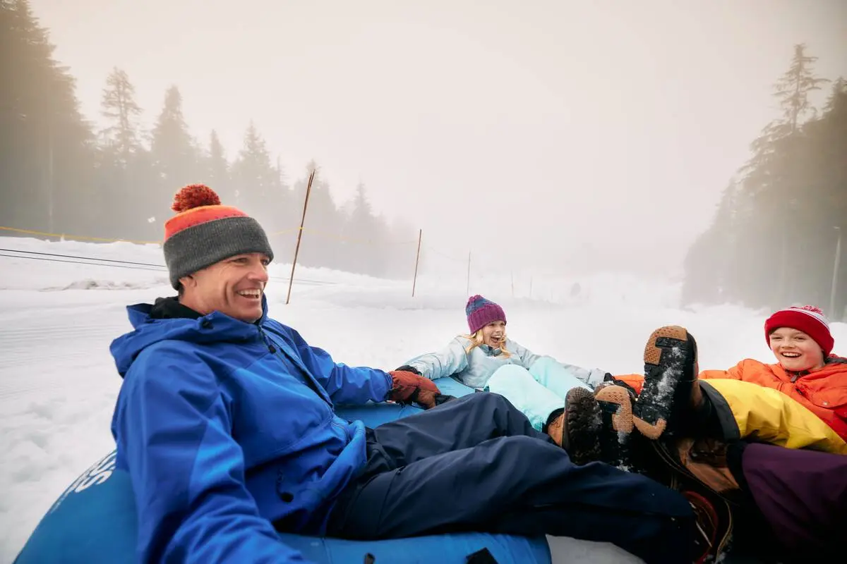 A family snow tubing at Cypress Mountain.