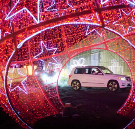 A car drives through Glow Gardens Langley