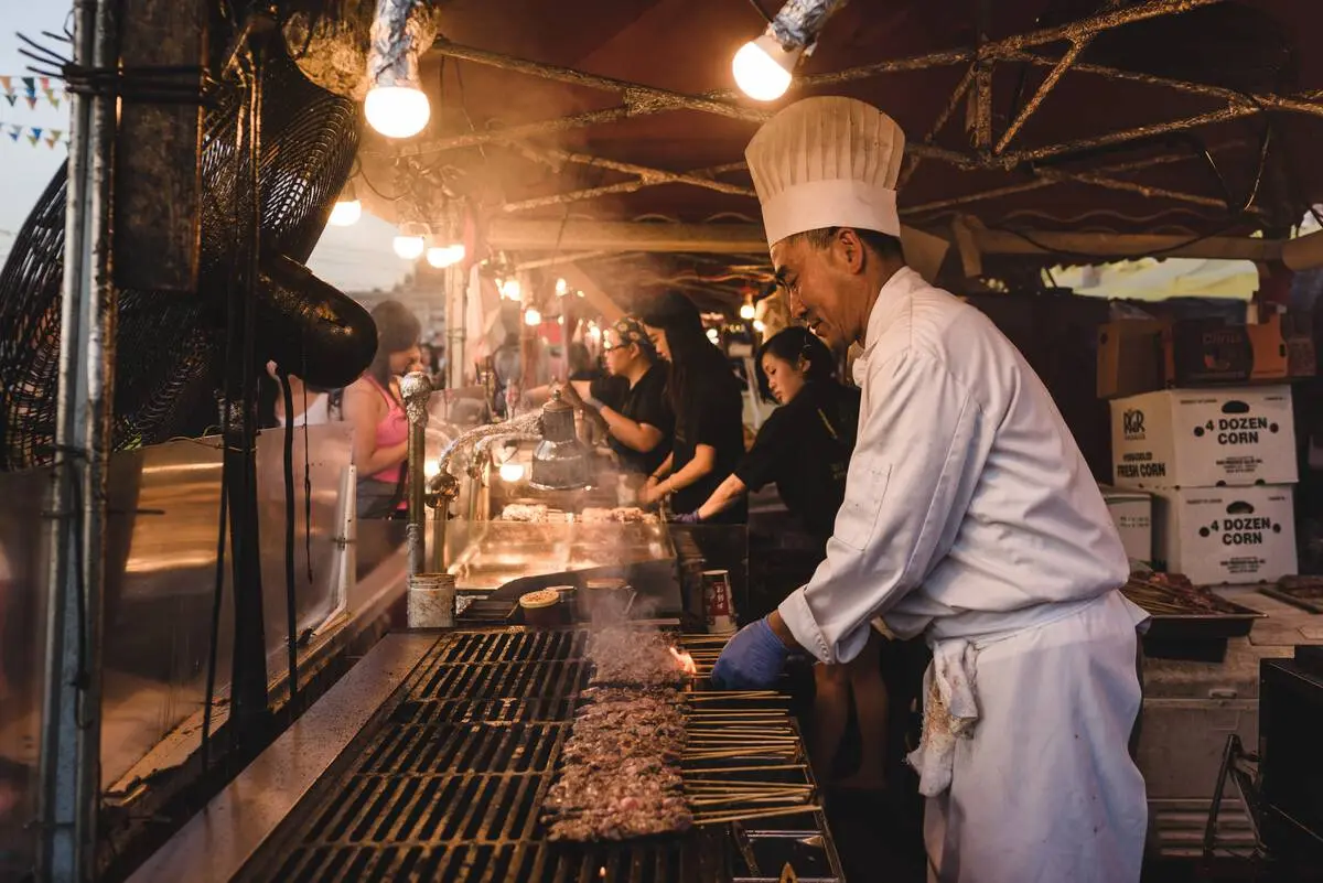 A chef prepares food at the Richmond Night Market.