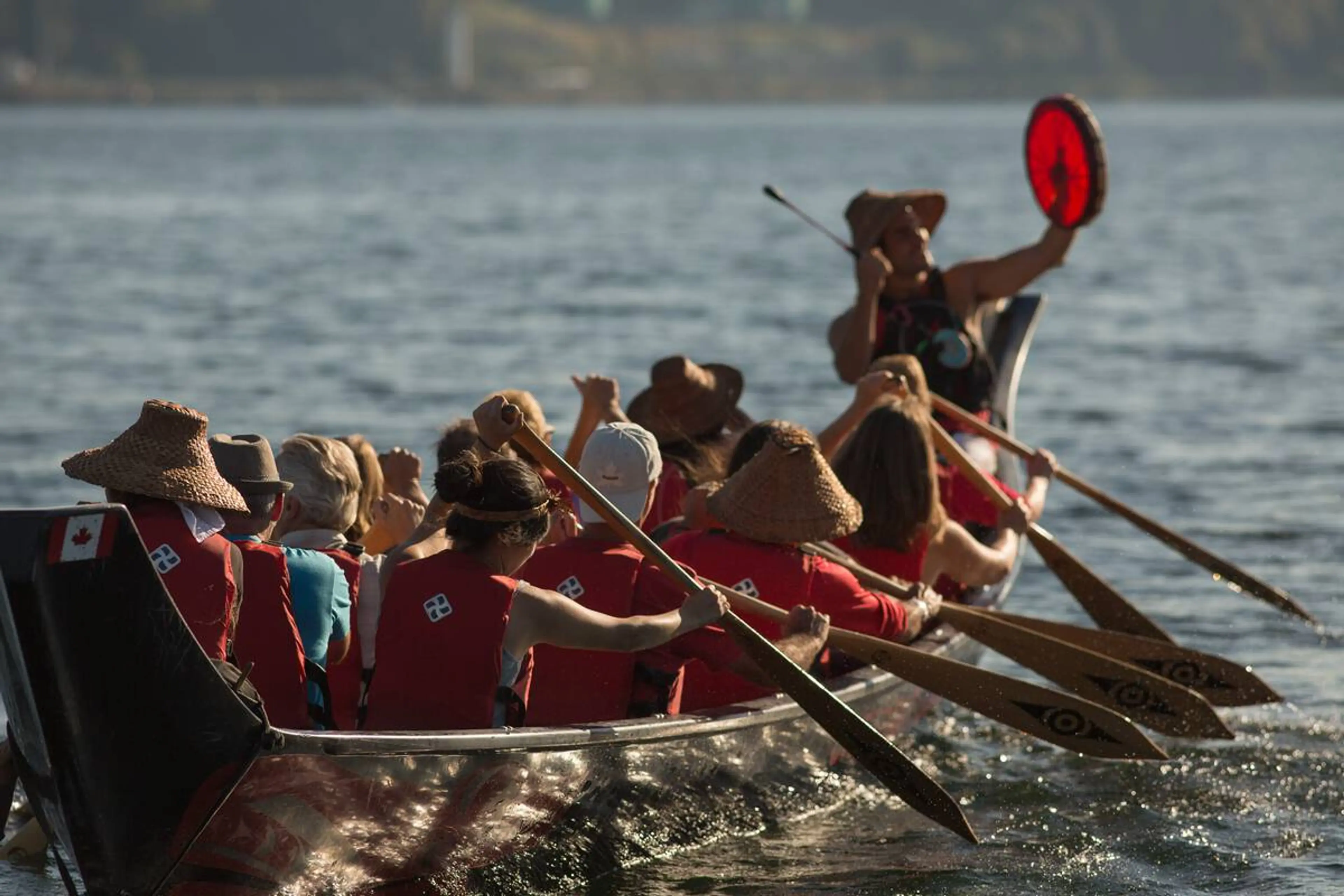 A group paddling a First Nations canoe with Takaya Tours. 