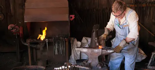At the Forge - Blacksmith working on the Anvil