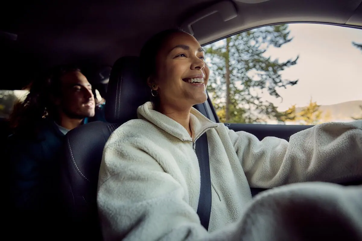 Two people in a car driving around Vancouver.