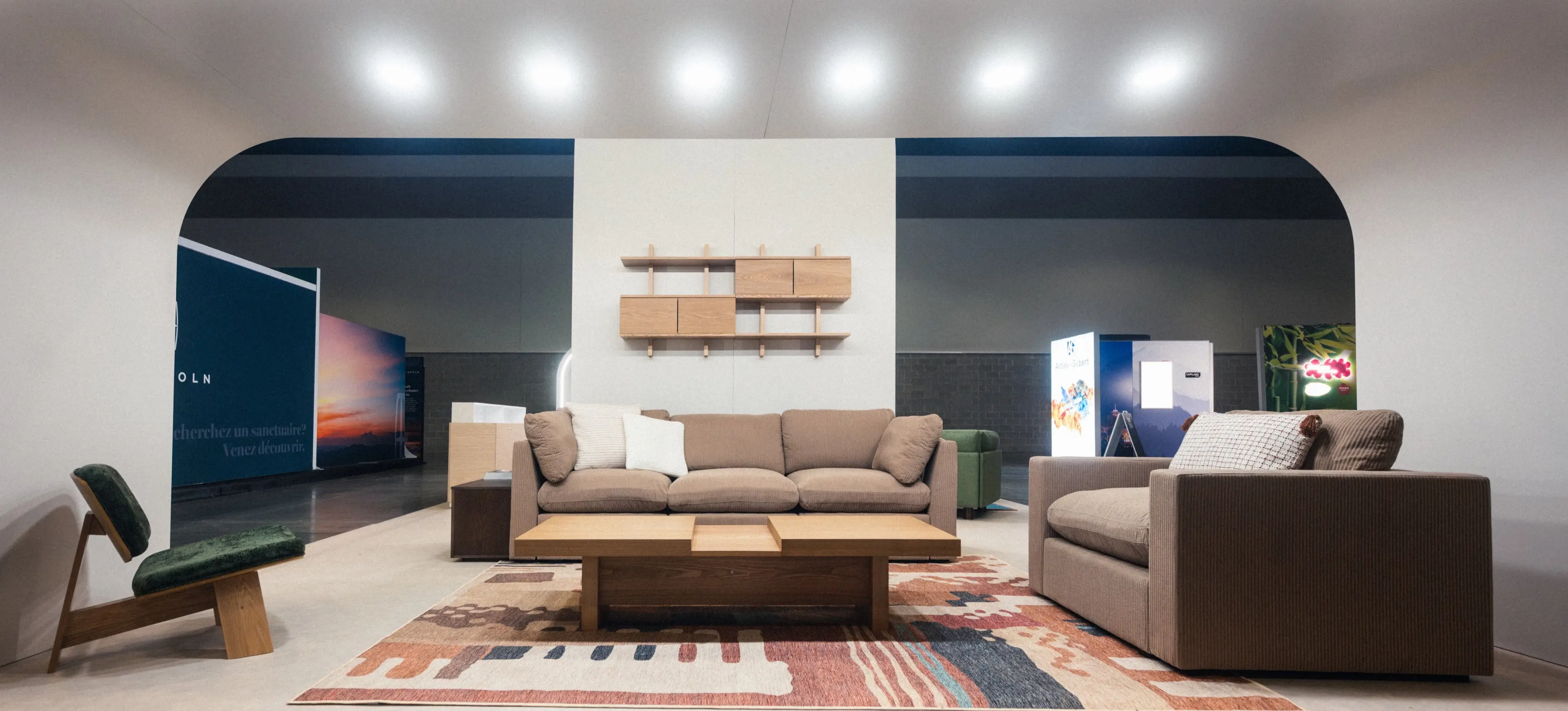 Modern living room setup with beige sofas, a wooden coffee table, a patterned rug, and a green cushioned chair under curved ceiling lights.