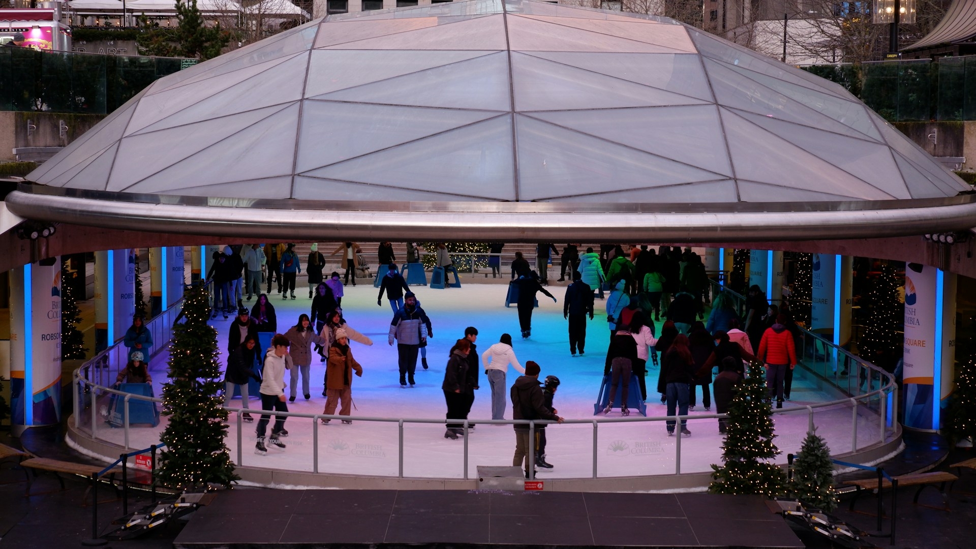 Skaters on the ice at the covered Robson Square Ice Rink in Vancouver.