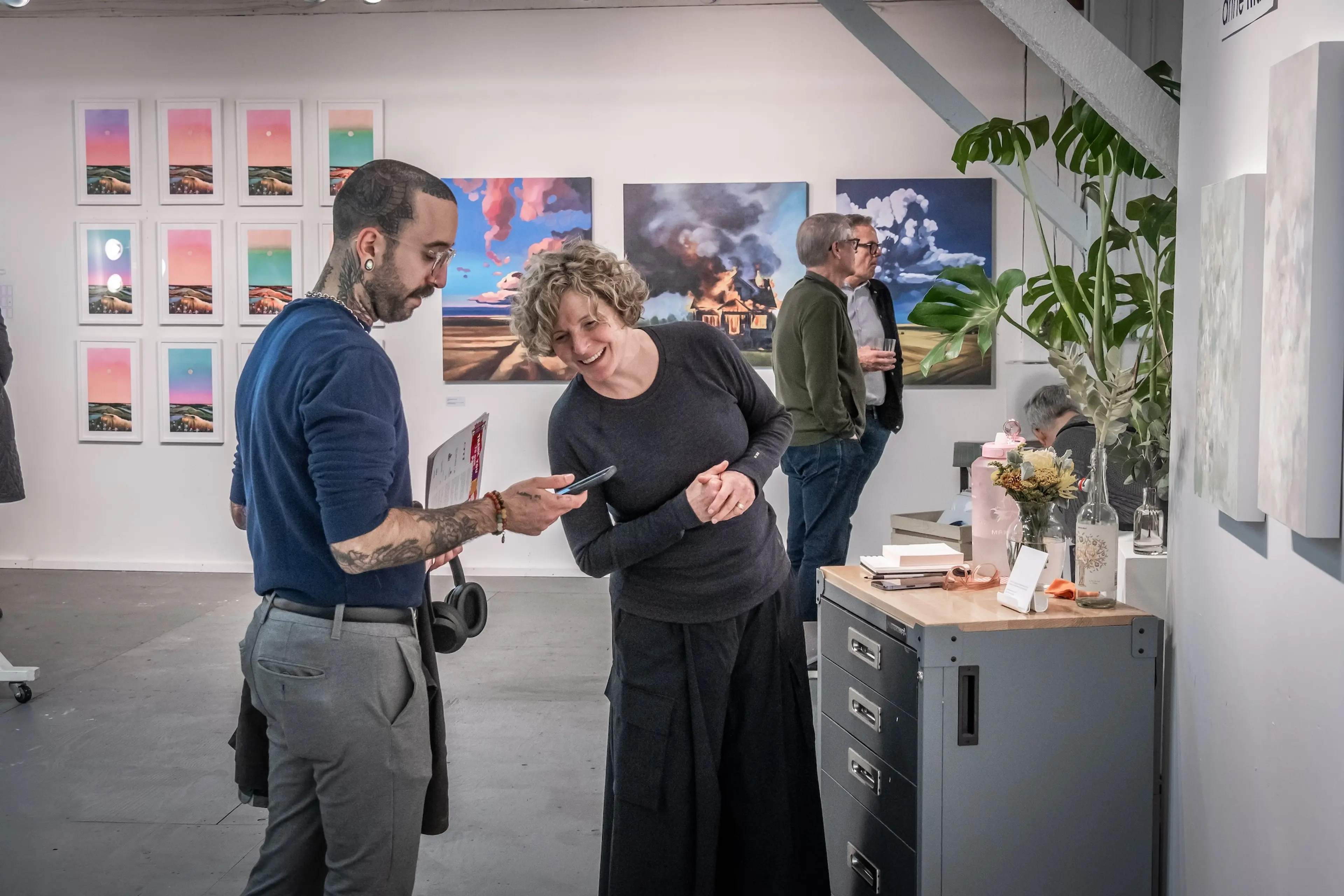 Artists Anne Mann interacts with a visitor in the Parker Street Studios during the Eastside Culture Crawl.