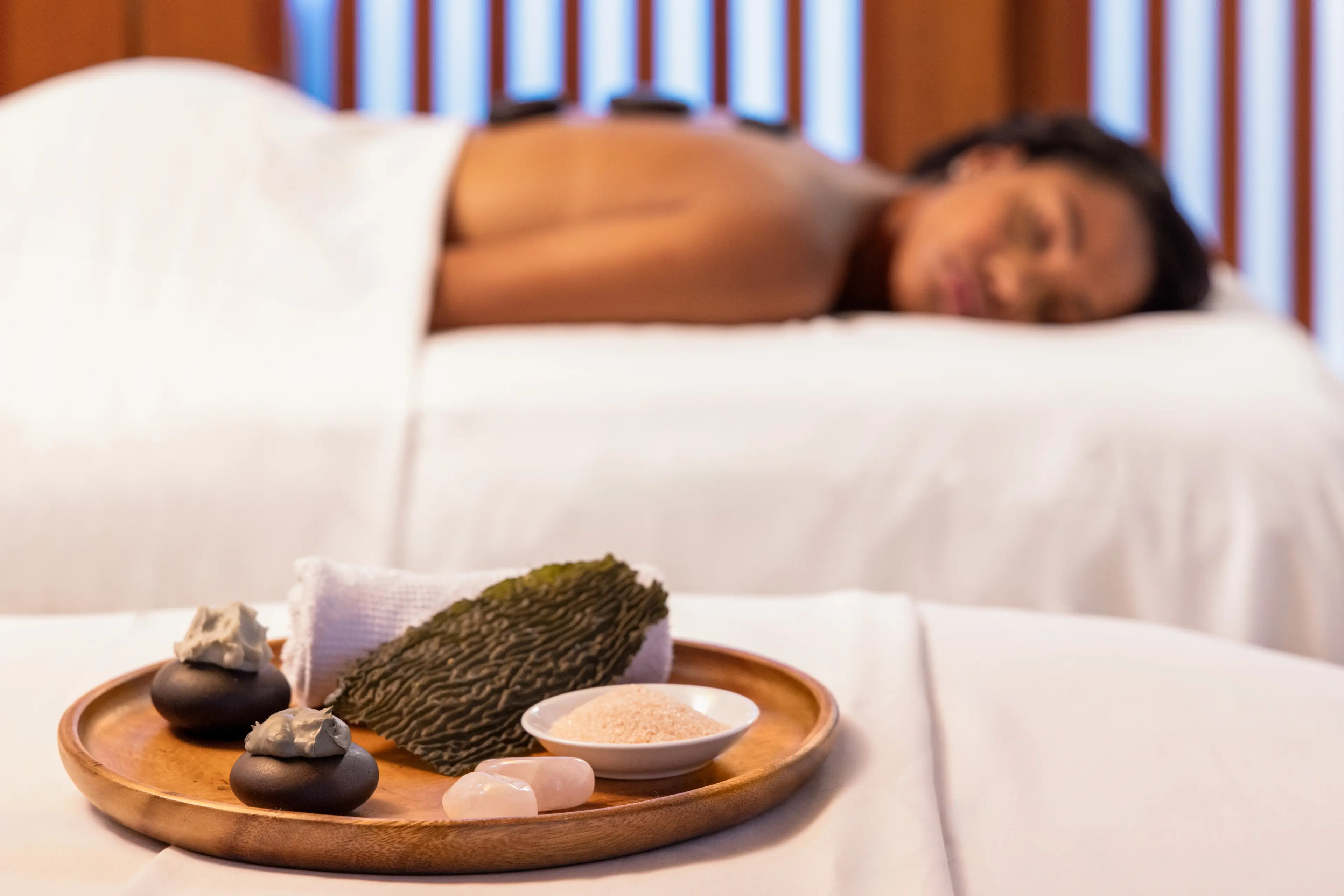  Woman on a massage table at the Fairmont Pacific Rim Willow Stream Spa in Vancouver.