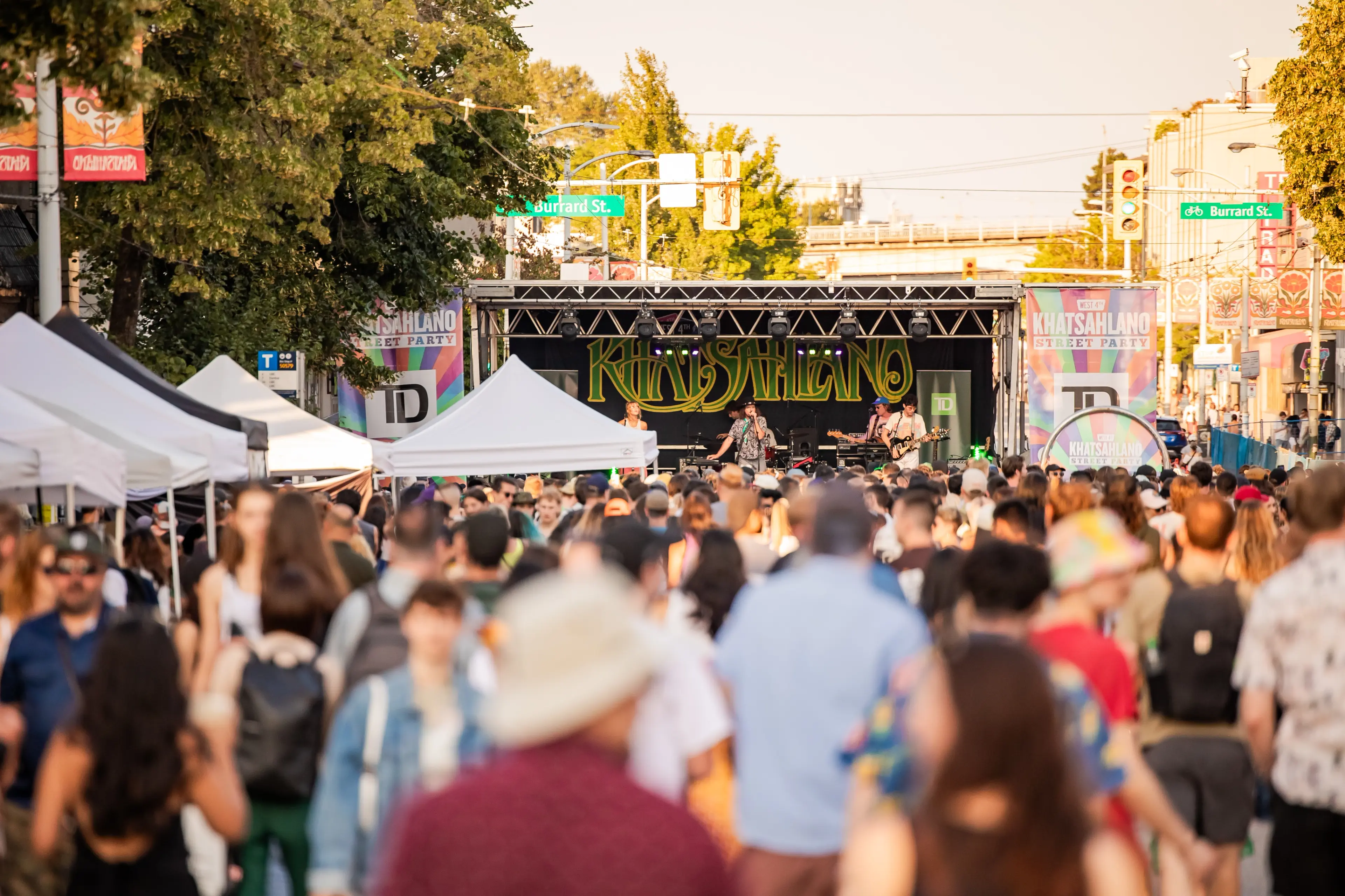 Crowd of people at the Khatsalano Street Party with a stage in the background displaying the word Khatsahlano.