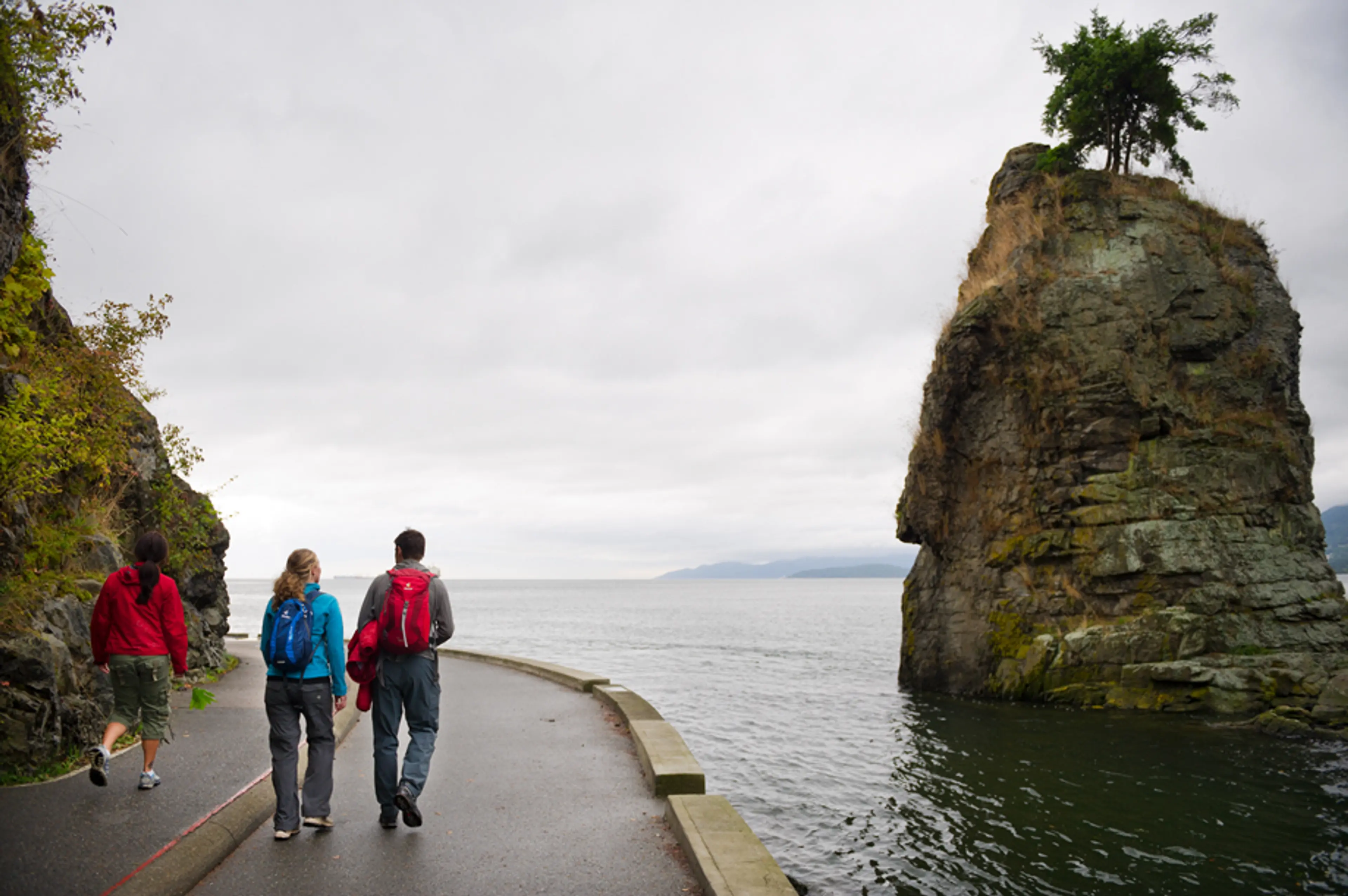 People walk on the seawall in Vancouver's Stanley Park