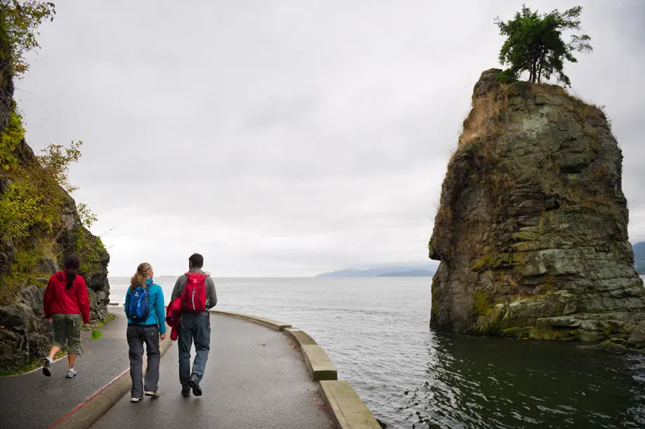 People walk on the seawall in Vancouver's Stanley Park
