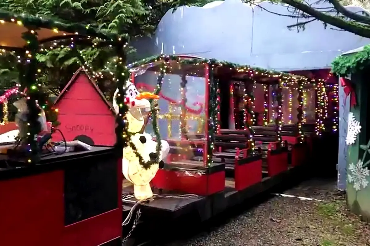 A miniature train decorated with Christmas lights and decor at Bear Creek Park in Surrey