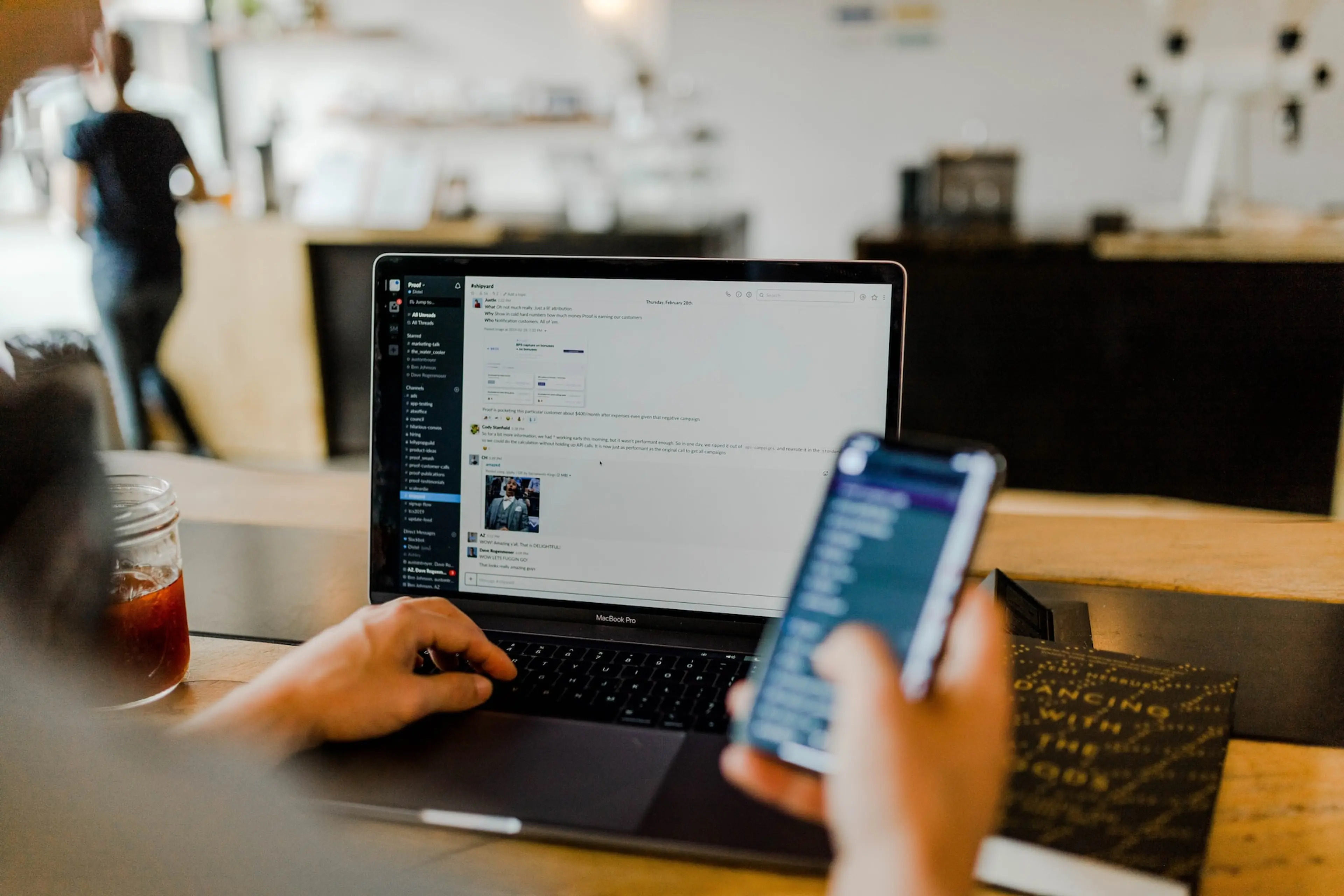 A person looks at a laptop screen with the Slack messenger.