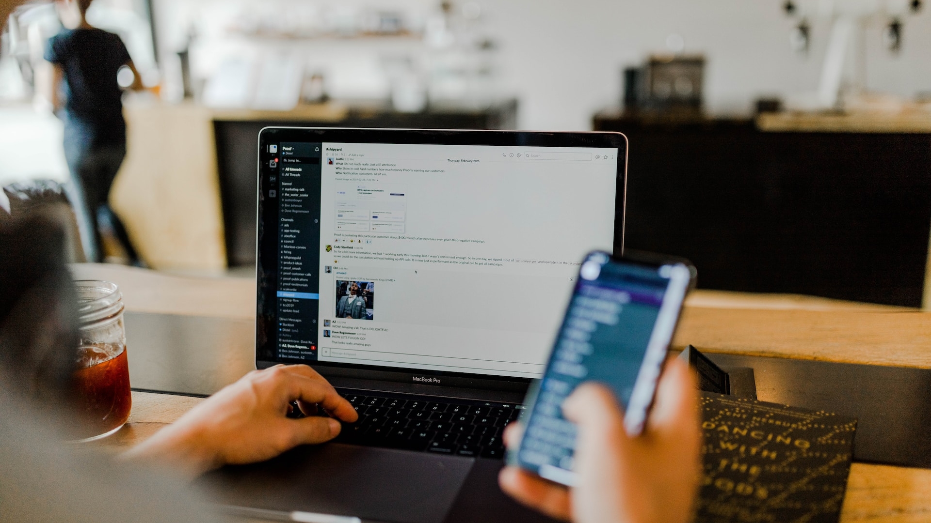 A person looks at a laptop screen with the Slack messenger.