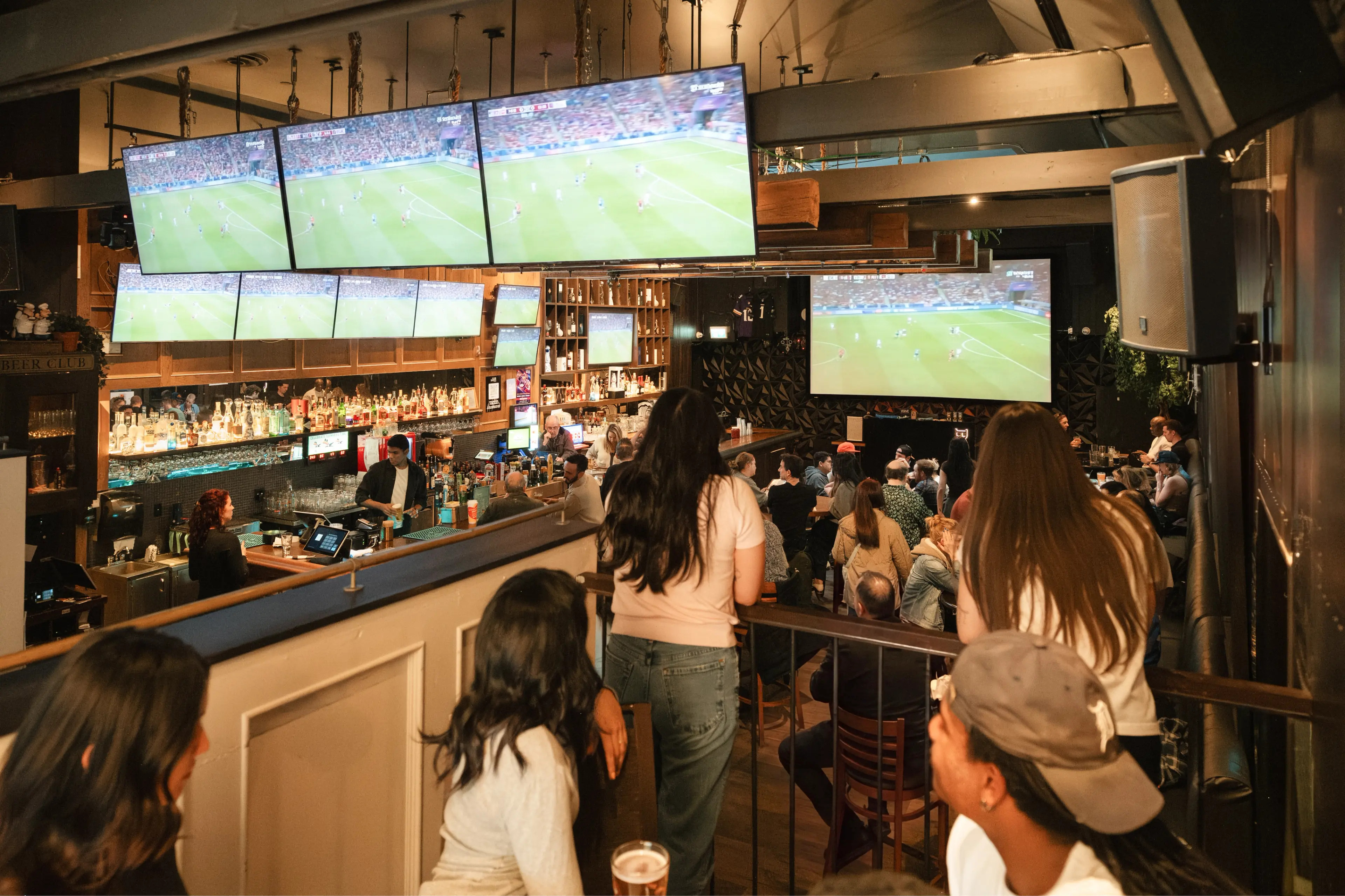 People watching soccer on a big screen at Bimini's in Vancouver.