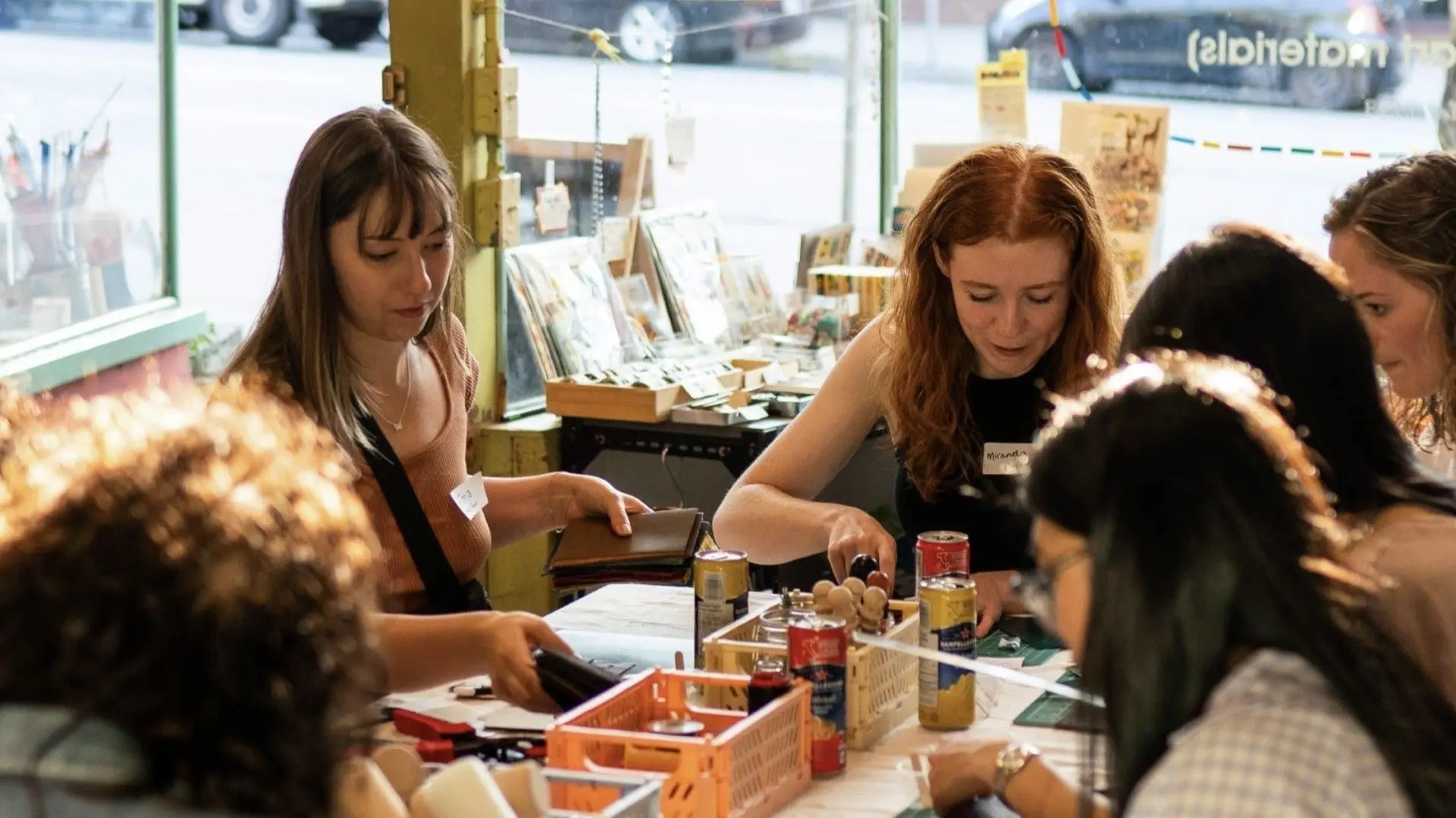 Attendees making bracelets at an Urban Source Friendship Bracelet Night