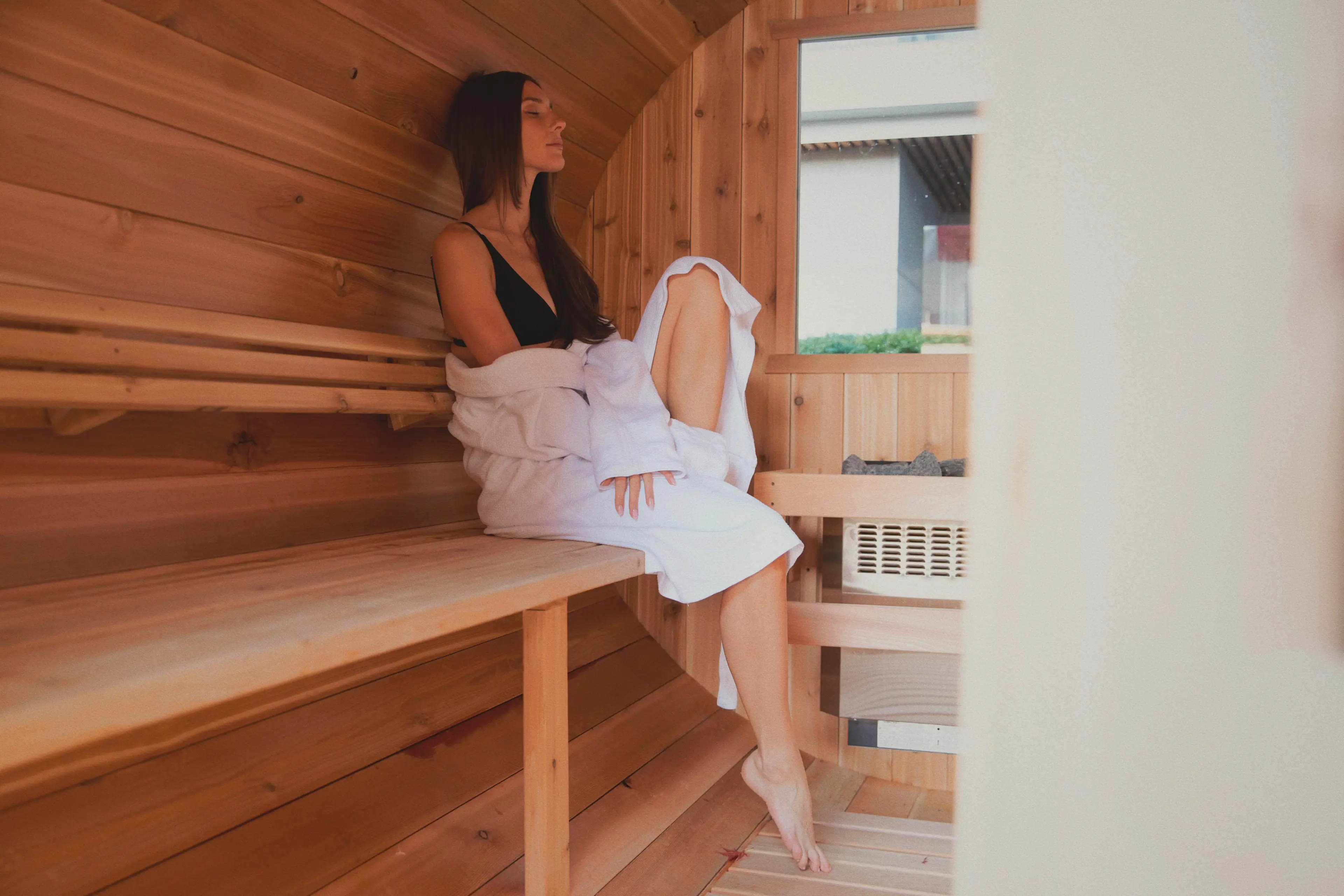 Person relaxes in the cedar sauna at the Spa at the Fairmont Pacific Rim