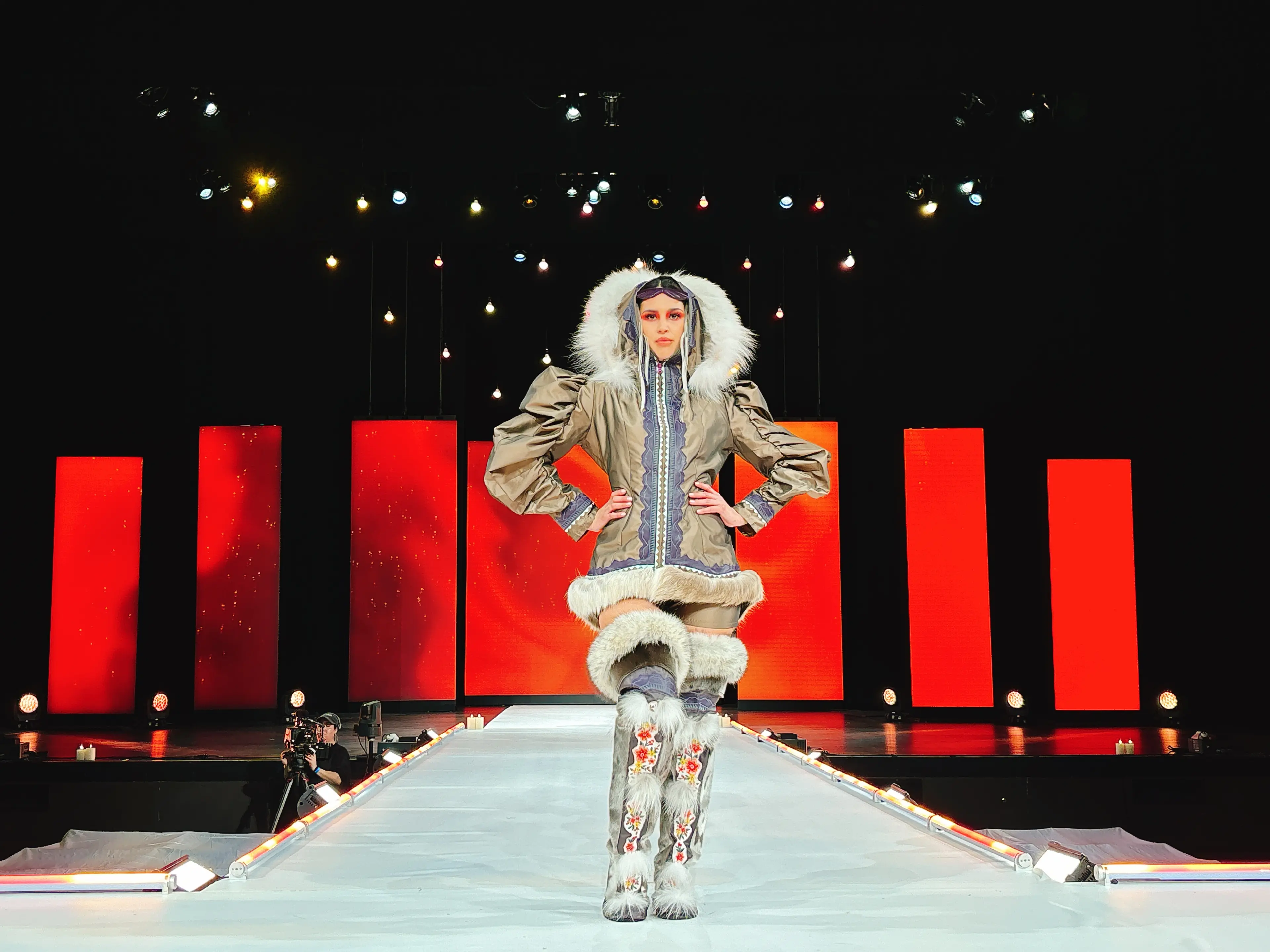 A model wearing fur cuffed boots and jacket on the runway at Vancouver Indigenous Fashion Week